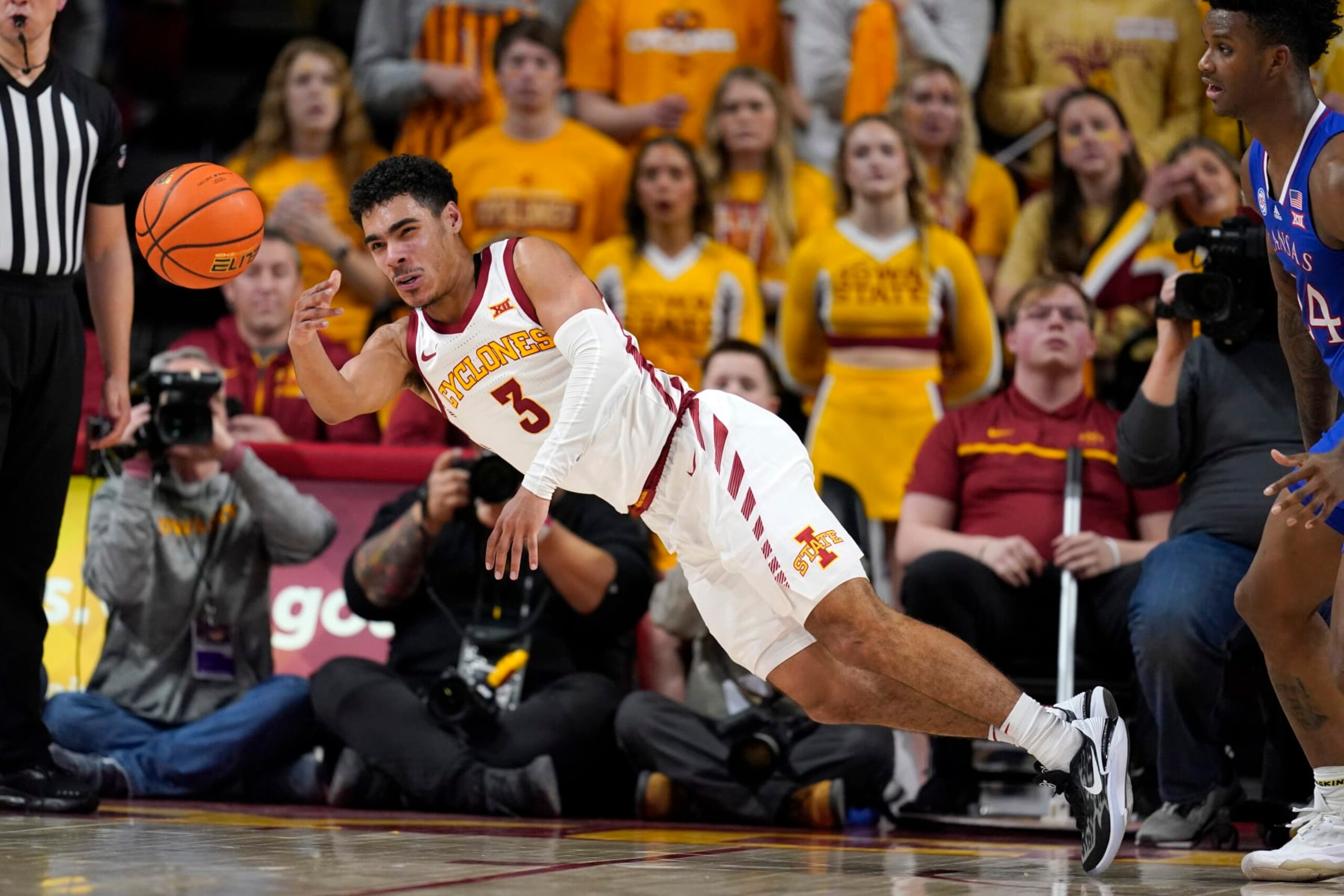 Iowa State guard Tamin Lipsey (3) passes to a teammate in front of Kansas forward K.J. Adams Jr., right, during the second half of an NCAA college basketball game, Saturday, Feb. 4, 2023, in Ames, Iowa. (AP Photo/Charlie Neibergall) Iowa State guard Tamin Lipsey (3) passes to a teammate in front of Kansas forward K.J. Adams Jr., right, during the second half of an NCAA college basketball game, Saturday, Feb. 4, 2023, in Ames, Iowa. (AP Photo/Charlie Neibergall)