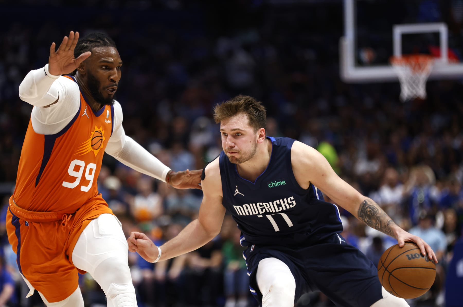 DALLAS, TX - MAY 8: Luka Doncic #77 of the Dallas Mavericks handles the ball as Jae Crowder #99 of the Phoenix Suns defends during the second half of Game Four of the 2022 NBA Playoffs Western Conference Semifinals at American Airlines Center on May 8, 2022 in Dallas, Texas. The Mavericks won 111-101. NOTE TO USER: User expressly acknowledges and agrees that, by downloading and or using this photograph, User is consenting to the terms and conditions of the Getty Images License Agreement. (Photo by Ron Jenkins/Getty Images)