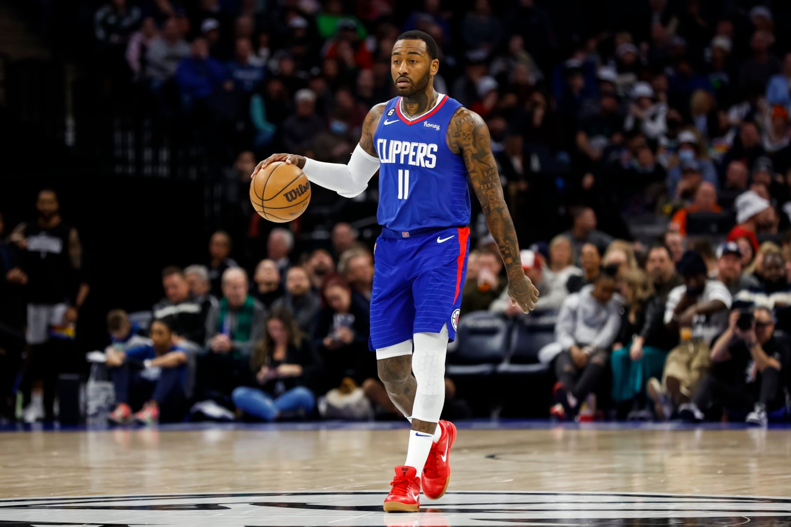 MINNEAPOLIS, MN - JANUARY 06: John Wall #11 of the LA Clippers dribbles the ball through center court against the Minnesota Timberwolves in the third quarter of the game at Target Center on January 6, 2023 in Minneapolis, Minnesota. The Timberwolves defeated the Clippers 128-115. NOTE TO USER: User expressly acknowledges and agrees that, by downloading and or using this Photograph, user is consenting to the terms and conditions of the Getty Images License Agreement. (Photo by David Berding/Getty Images)
