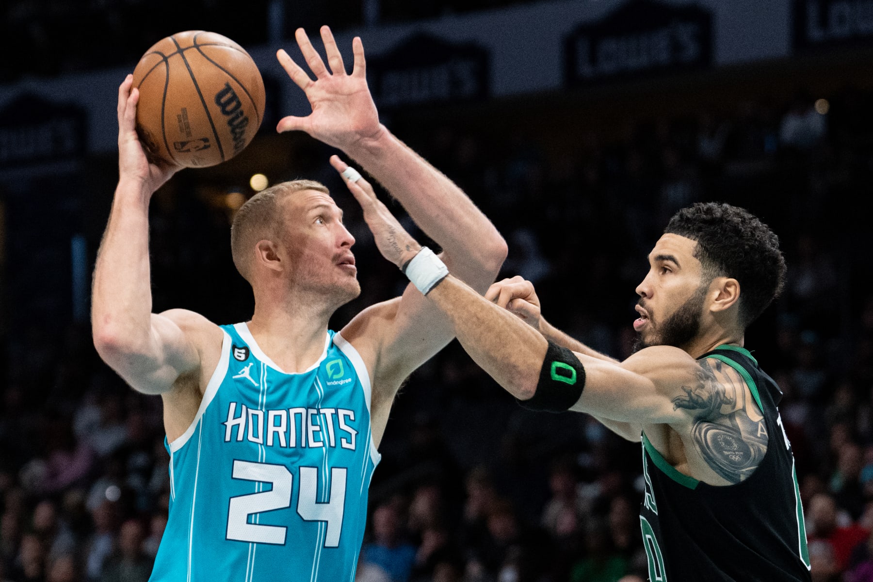 CHARLOTTE, NORTH CAROLINA - JANUARY 16: Mason Plumlee #24 of the Charlotte Hornets drives to the basket while guarded by Jayson Tatum #0 of the Boston Celtics in the fourth quarter during their game at Spectrum Center on January 16, 2023 in Charlotte, North Carolina. NOTE TO USER: User expressly acknowledges and agrees that, by downloading and or using this photograph, User is consenting to the terms and conditions of the Getty Images License Agreement. (Photo by Jacob Kupferman/Getty Images)
