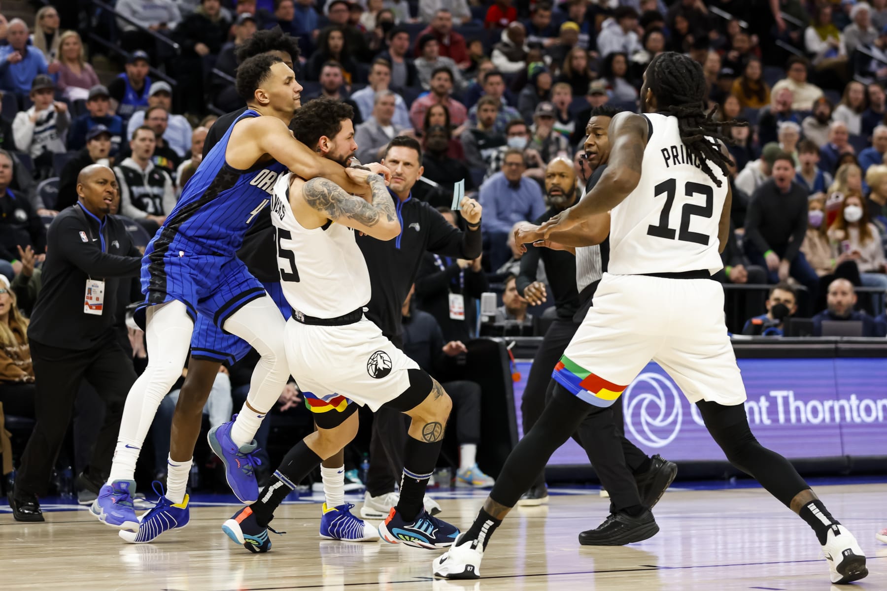 MINNEAPOLIS, MN - FEBRUARY 03: Jalen Suggs #4 of the Orlando Magic and Austin Rivers #25 of the Minnesota Timberwolves get into a scrum as Taurean Prince #12 reacts in the third quarter of the game at Target Center on February 03, 2023 in Minneapolis, Minnesota. Suggs and Rivers were ejected from the game. NOTE TO USER: User expressly acknowledges and agrees that, by downloading and or using this Photograph, user is consenting to the terms and conditions of the Getty Images License Agreement. (Photo by David Berding/Getty Images)