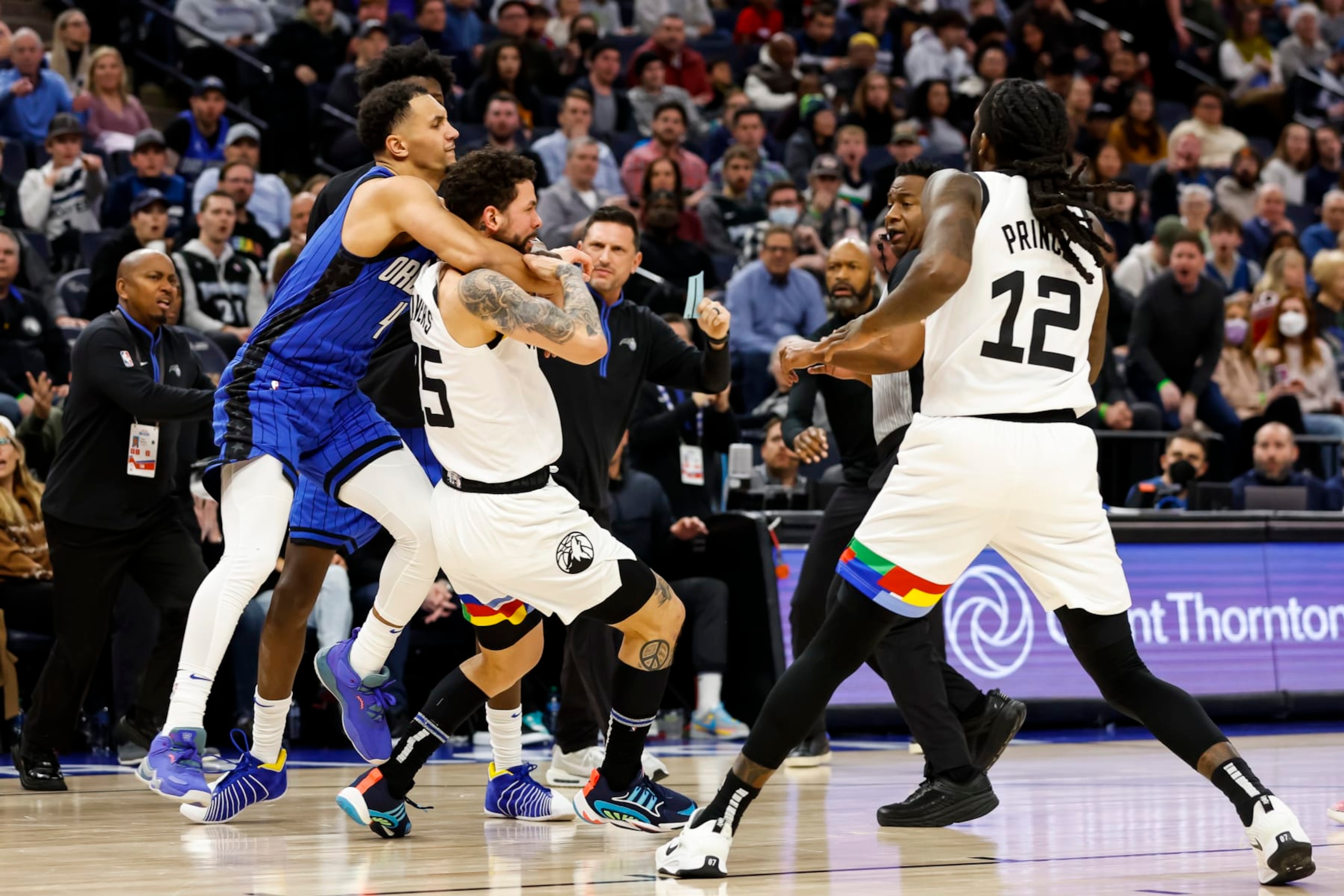 MINNEAPOLIS, MN - FEBRUARY 03: Jalen Suggs #4 of the Orlando Magic and Austin Rivers #25 of the Minnesota Timberwolves get into a scrum as Taurean Prince #12 reacts in the third quarter of the game at Target Center on February 03, 2023 in Minneapolis, Minnesota. Suggs and Rivers were ejected from the game. NOTE TO USER: User expressly acknowledges and agrees that, by downloading and or using this Photograph, user is consenting to the terms and conditions of the Getty Images License Agreement. (Photo by David Berding/Getty Images)