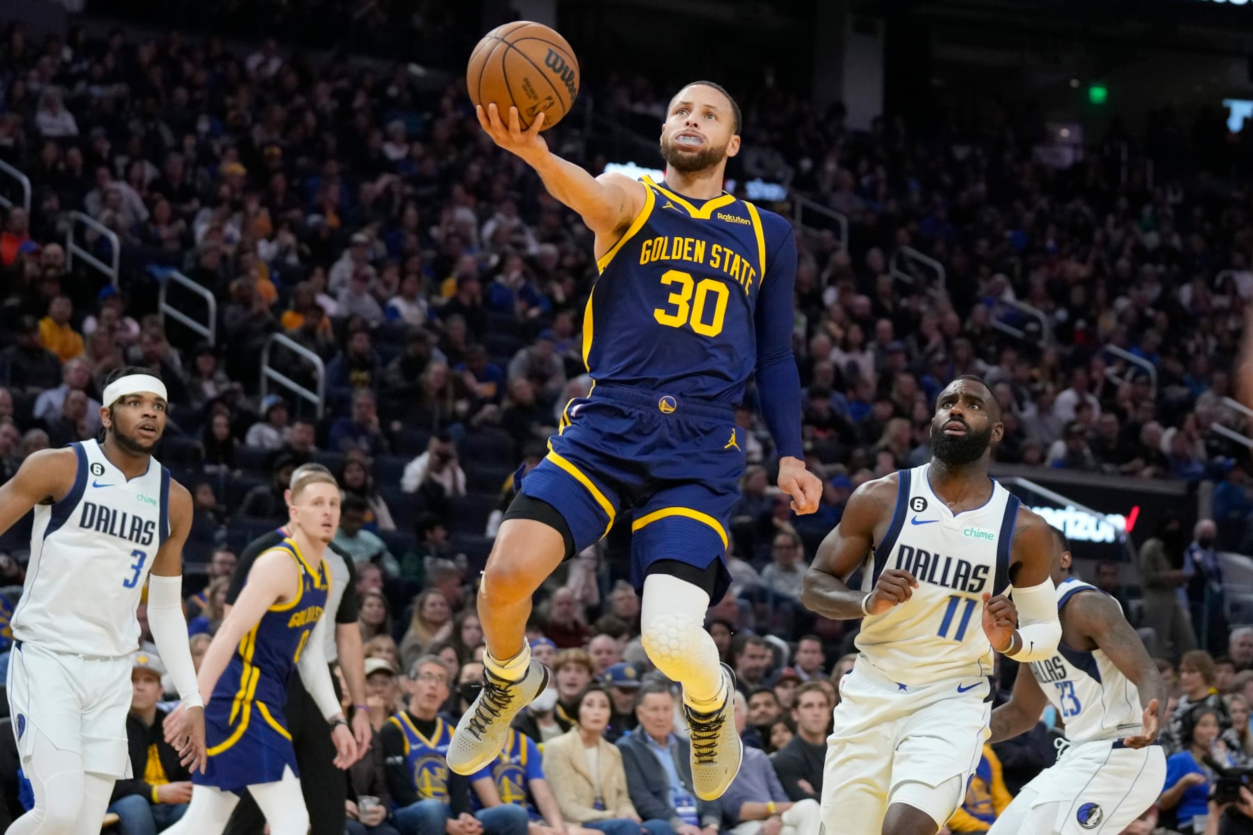 Golden State Warriors guard Stephen Curry (30) shoots against Dallas Mavericks forward Tim Hardaway Jr. (11) during the second half of an NBA basketball game in San Francisco, Saturday, Feb. 4, 2023. (AP Photo/Jeff Chiu)