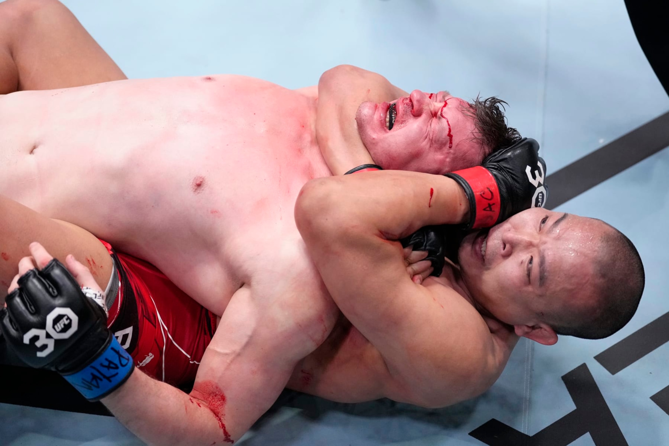 LAS VEGAS, NEVADA - FEBRUARY 04: (R-L) Junyong Park of South Korea secures a rear choke submission against Denis Tiuliulin of Russia in a middleweight fight during the UFC Fight Night event at UFC APEX on February 04, 2023 in Las Vegas, Nevada. (Photo by Jeff Bottari/Zuffa LLC via Getty Images)