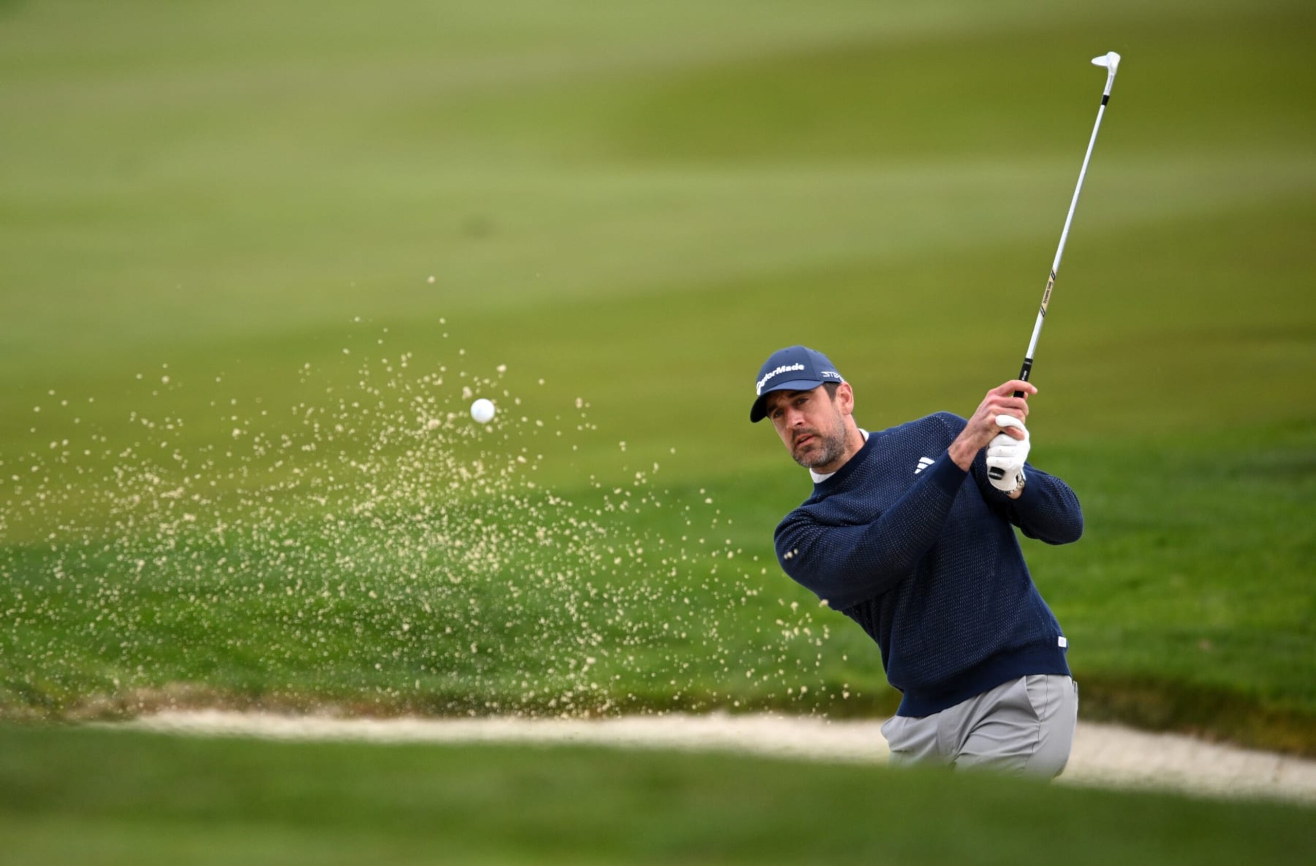 PEBBLE BEACH, CALIFORNIA - FEBRUARY 03: Aaron Rodgers plays a shot from a bunker on the fifth hole during the second round of the AT&T Pebble Beach Pro-Am at Monterey Peninsula Country Club on February 03, 2023 in Pebble Beach, California. (Photo by Orlando Ramirez/Getty Images) PEBBLE BEACH, CALIFORNIA - FEBRUARY 03: Aaron Rodgers plays a shot from a bunker on the fifth hole during the second round of the AT&T Pebble Beach Pro-Am at Monterey Peninsula Country Club on February 03, 2023 in Pebble Beach, California. (Photo by Orlando Ramirez/Getty Images)