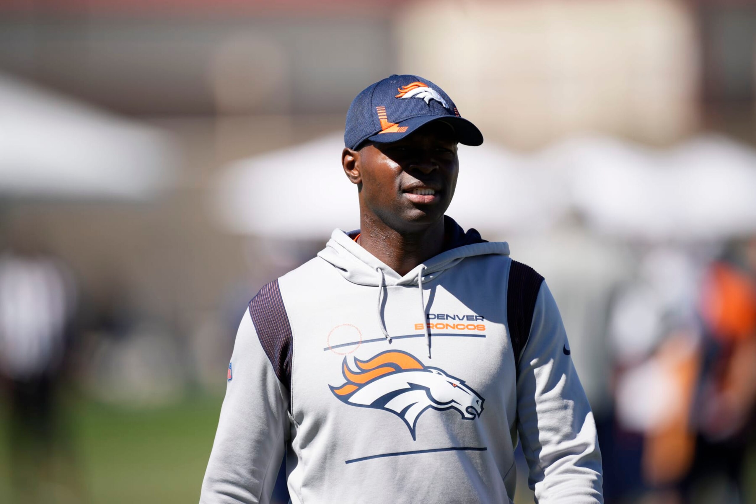Denver Broncos defensive coordinator Ejiro Evero takes part in drills during the NFL football team's training camp Saturday, Aug. 6, 2022, at the Broncos' headquarters in Centennial, Colo. (AP Photo/David Zalubowski)