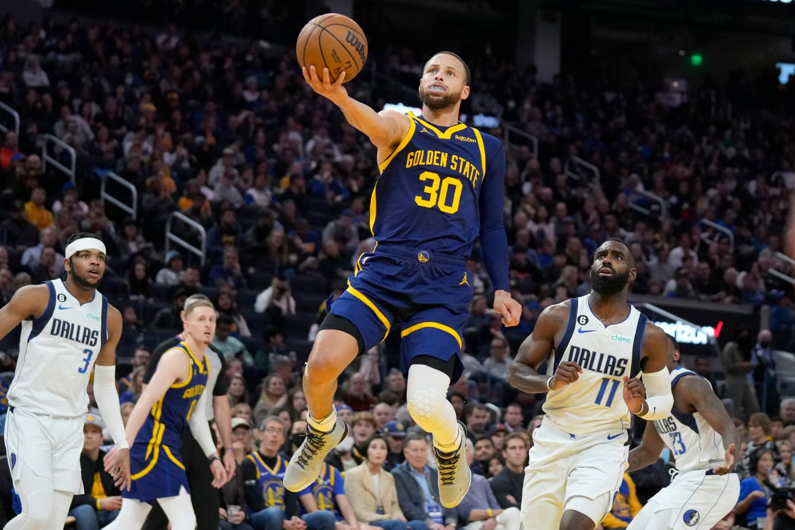Golden State Warriors guard Stephen Curry (30) shoots against Dallas Mavericks forward Tim Hardaway Jr. (11) during the second half of an NBA basketball game in San Francisco, Saturday, Feb. 4, 2023. (AP Photo/Jeff Chiu)