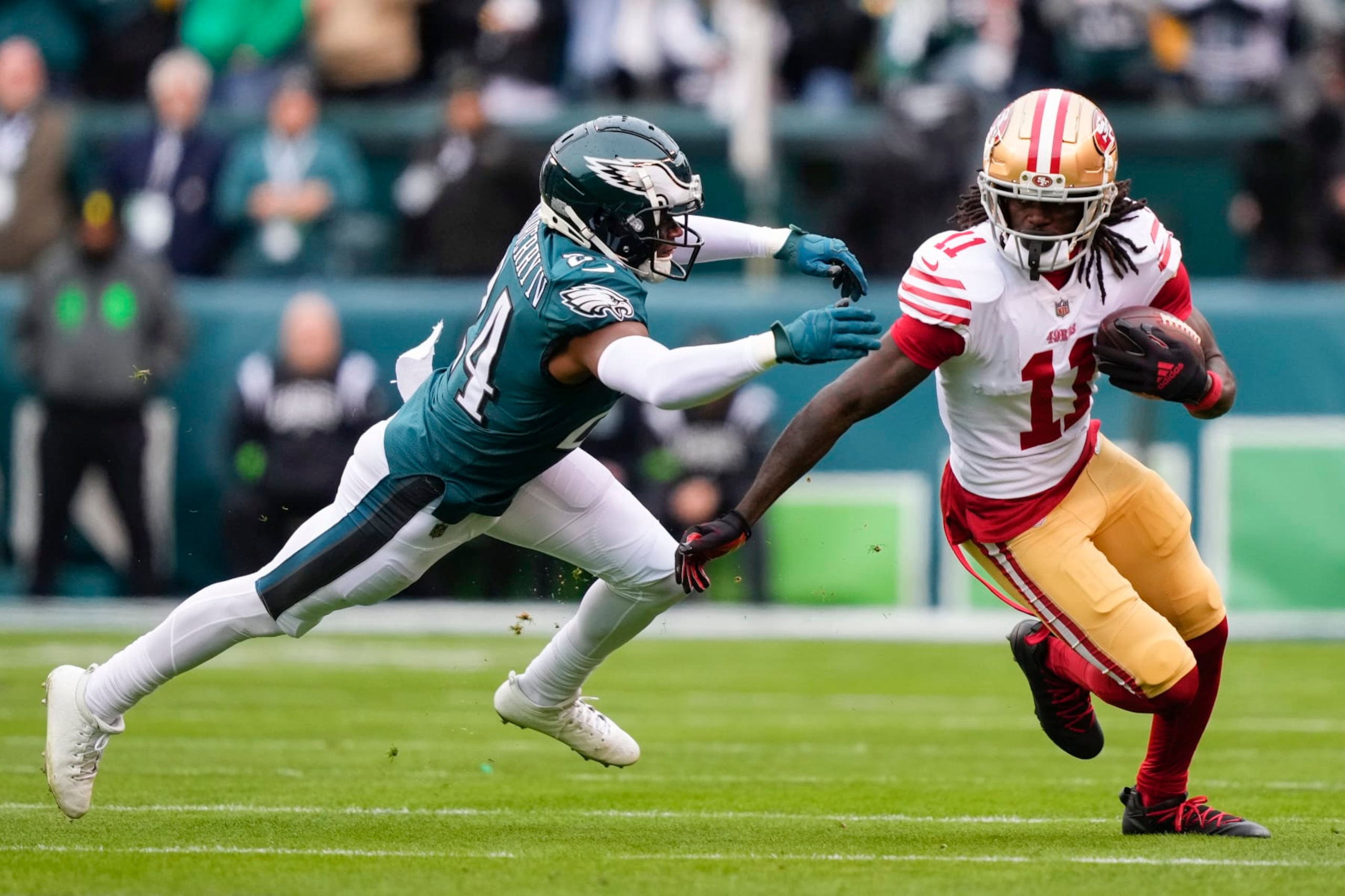 San Francisco 49ers wide receiver Brandon Aiyuk, right, runs with the ball against Philadelphia Eagles cornerback James Bradberry (24) during the first half of the NFC Championship NFL football game Sunday, Jan. 29, 2023, in Philadelphia. (AP Photo/Matt Rourke)