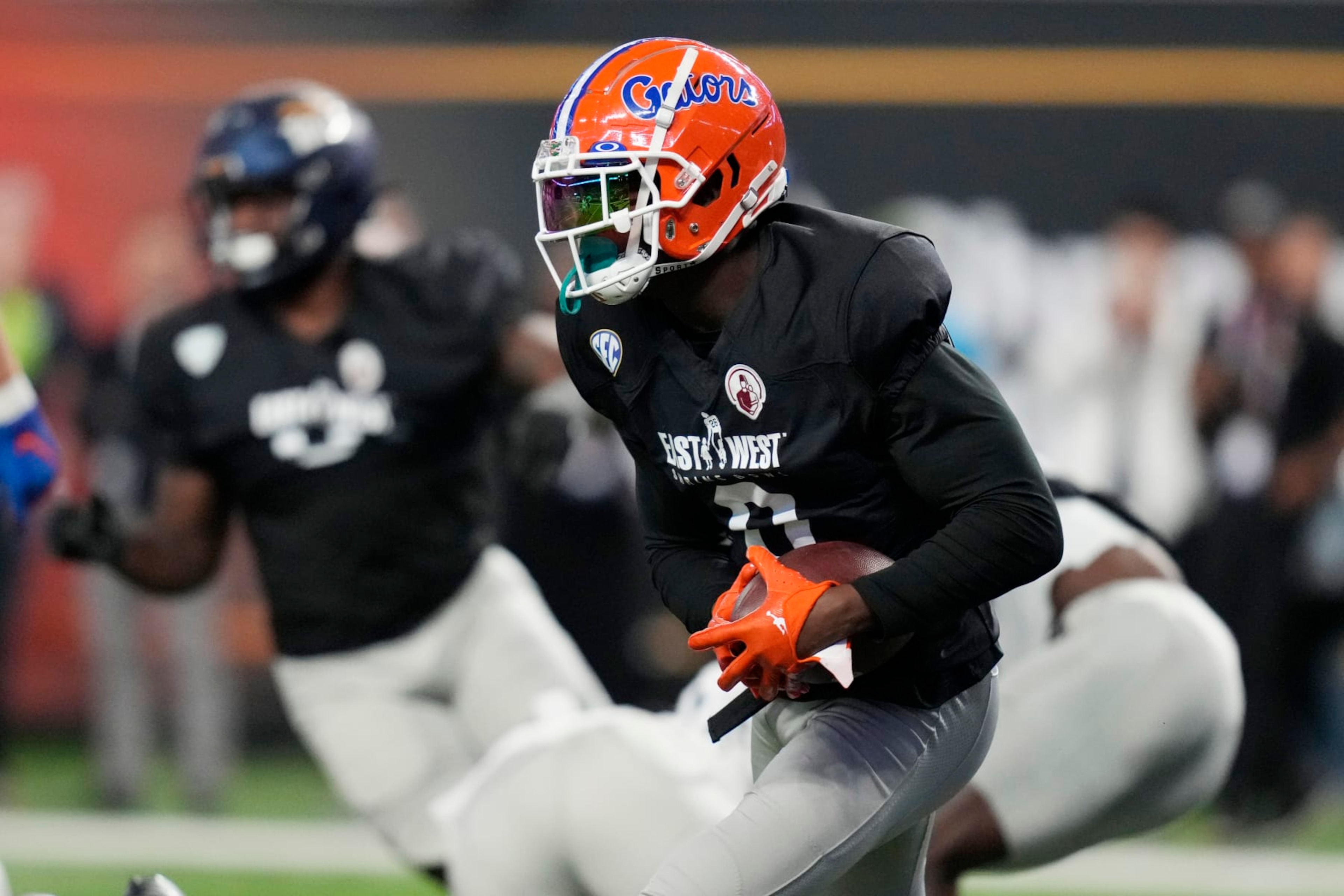 West safety Trey Dean III of Florida runs after making an interception against East during the first half of the East-West Shrine Bowl NCAA college football game Thursday, Feb. 2, 2023, in Las Vegas. (AP Photo/John Locher)