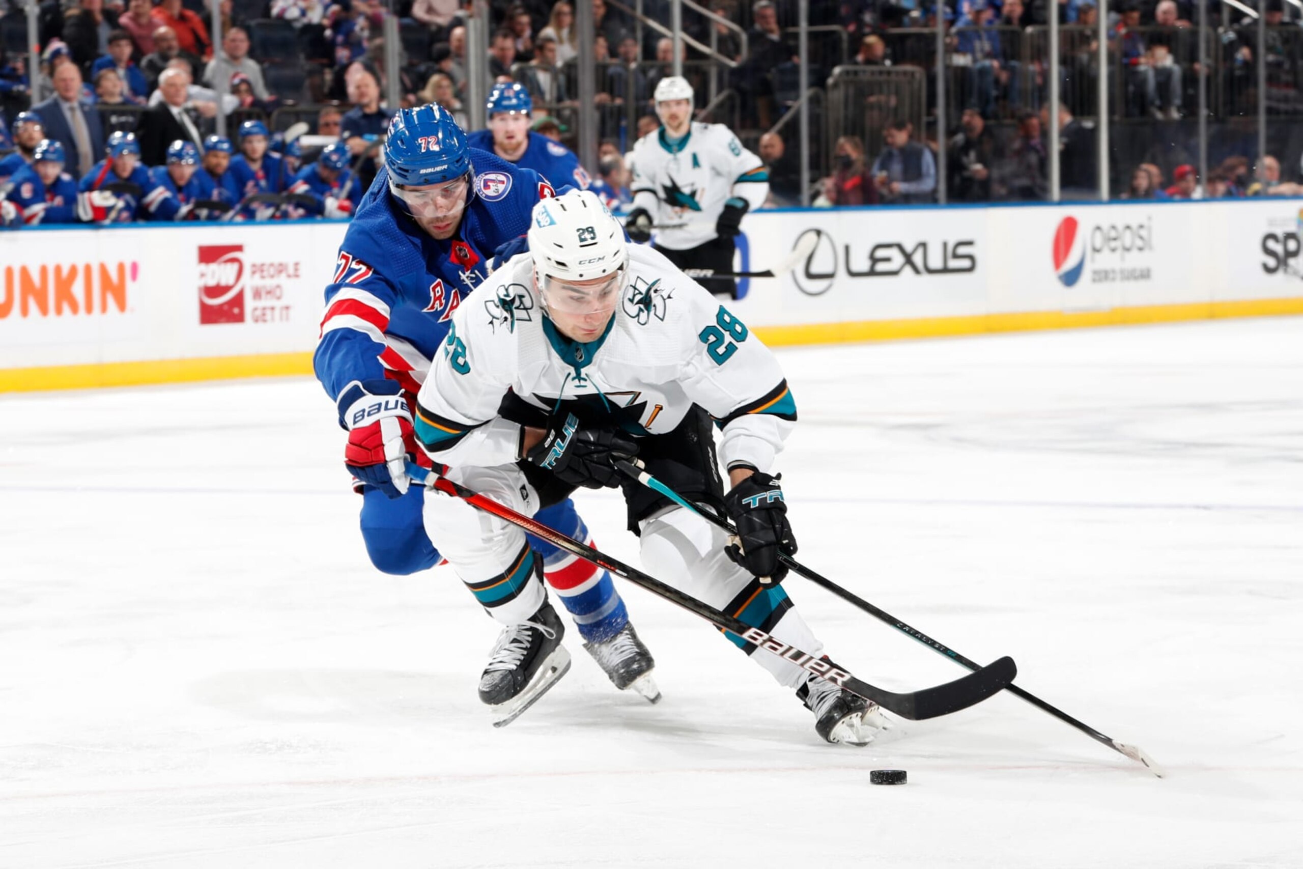 NEW YORK, NY - DECEMBER 03:  Timo Meier #28 of the San Jose Sharks skates with the puck against Filip Chytil #72 of the New York Rangers at Madison Square Garden on December 3, 2021 in New York City. (Photo by Jared Silber/NHLI via Getty Images)