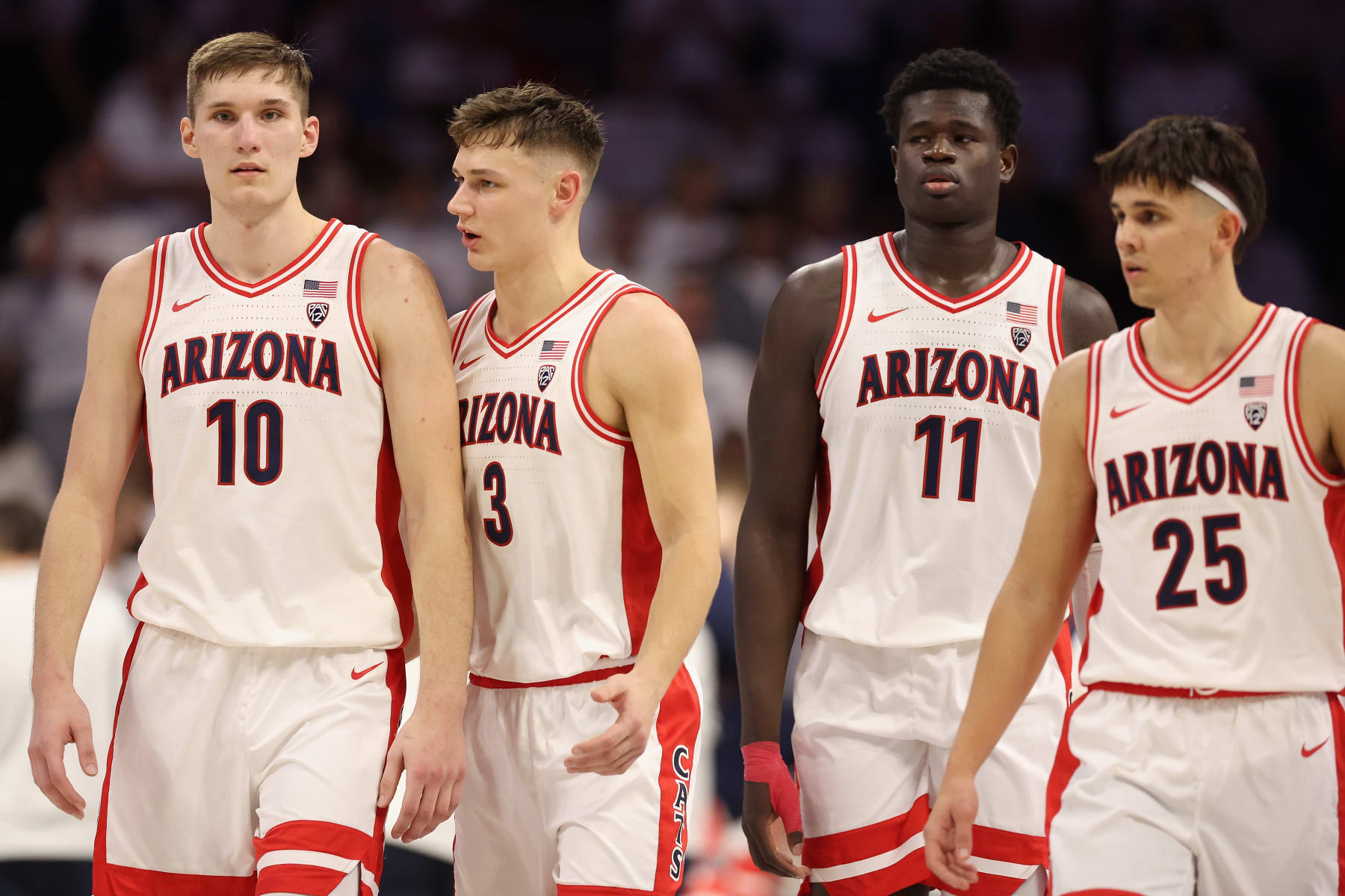 TUCSON, ARIZONA - JANUARY 21: (L-R) Azuolas Tubelis #10, Pelle Larsson #3, Oumar Ballo #11 and Kerr Kriisa #25 of the Arizona Wildcats walk down the court during the second half of the NCAA game at McKale Center on January 21, 2023 in Tucson, Arizona.  The Wildcats defeated the Bruins 58-52.  (Photo by Christian Petersen/Getty Images)