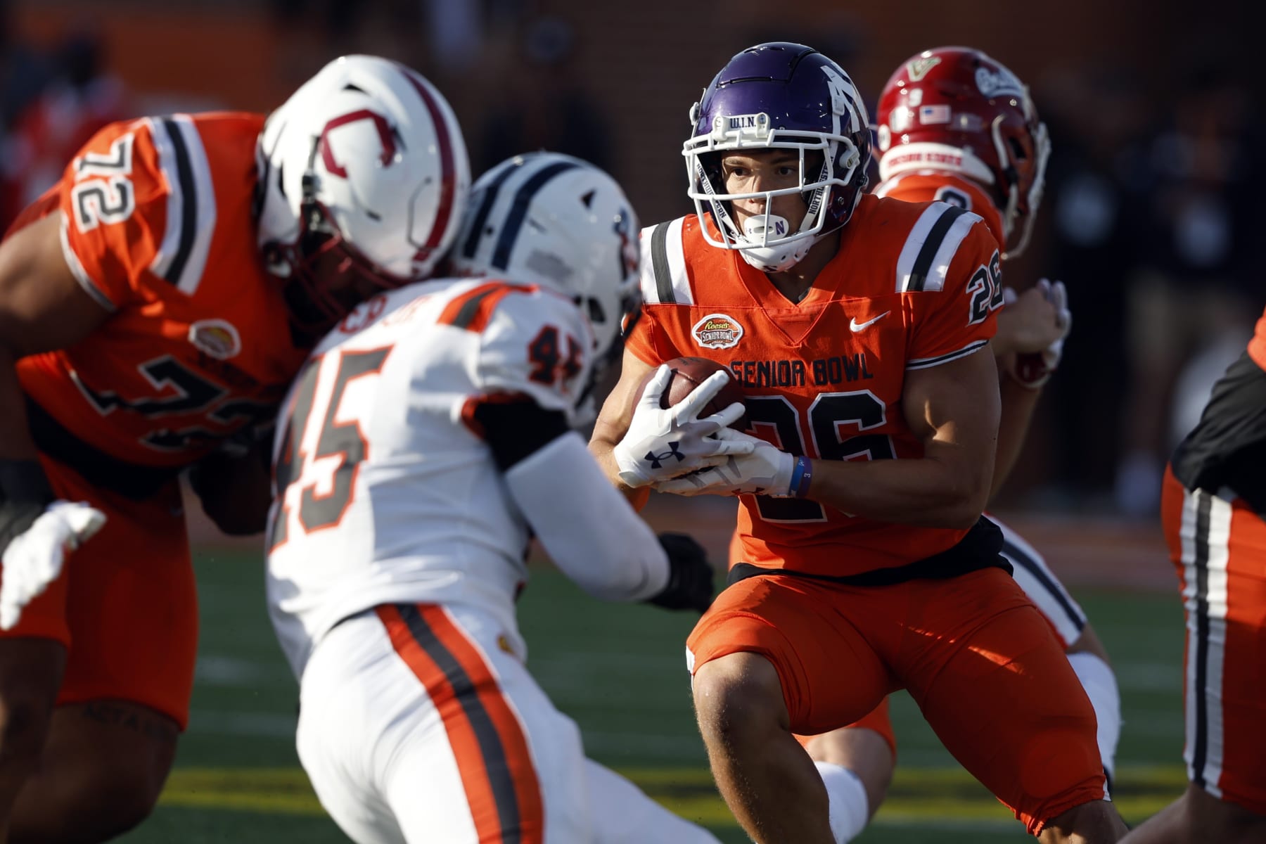 National running back Evan Hull (26), of Northwestern, carries the ball during the second half of the Senior Bowl NCAA college football game Saturday, Feb. 4, 2023, in Mobile, Ala.. (AP Photo/Butch Dill)
