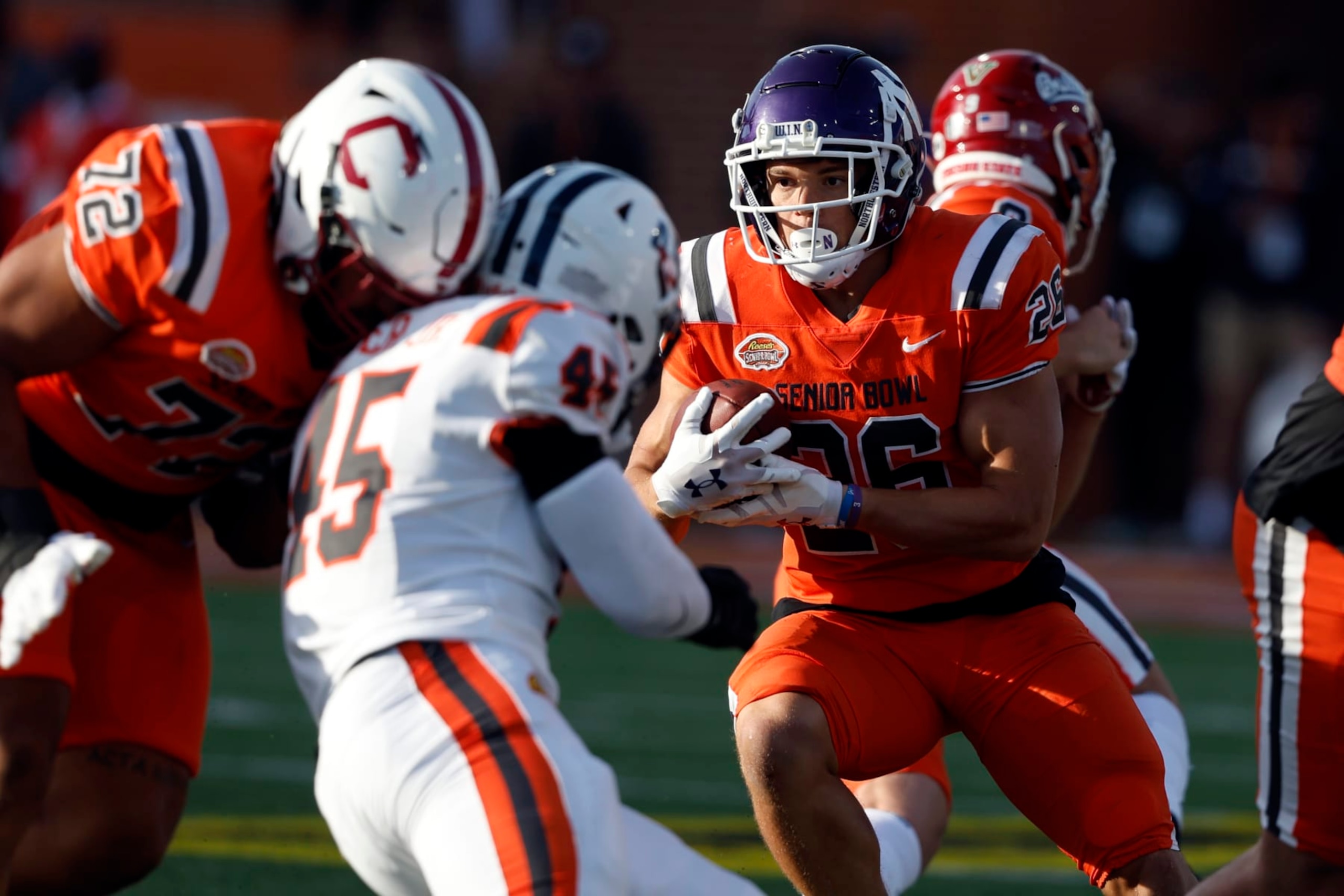 National running back Evan Hull (26), of Northwestern, carries the ball during the second half of the Senior Bowl NCAA college football game Saturday, Feb. 4, 2023, in Mobile, Ala.. (AP Photo/Butch Dill)