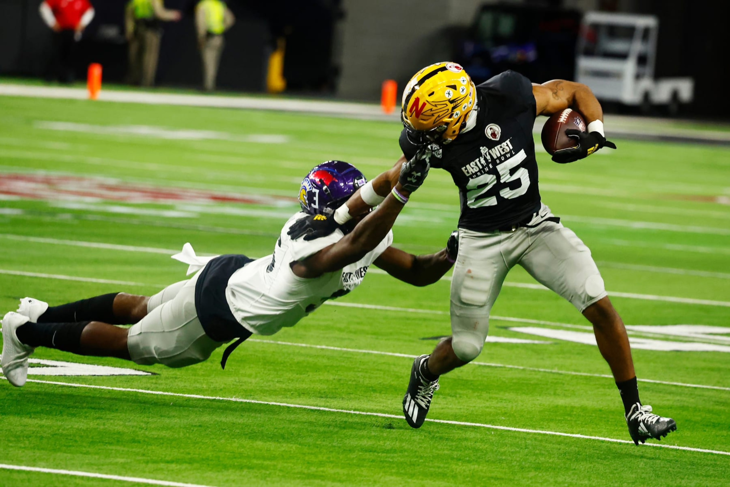 LAS VEGAS, NV - FEBRUARY 02: Arizona State Wildcats running back Xazavian Valladay (#25) has his face mask pulled by Stephen F. Austin edge BJ Thompson (#96) during the East-West Shrine Bowl on February 2, 2023 at Allegiant Stadium in Las Vegas, Nevada. (Photo by Jeff Speer/Icon Sportswire via Getty Images)