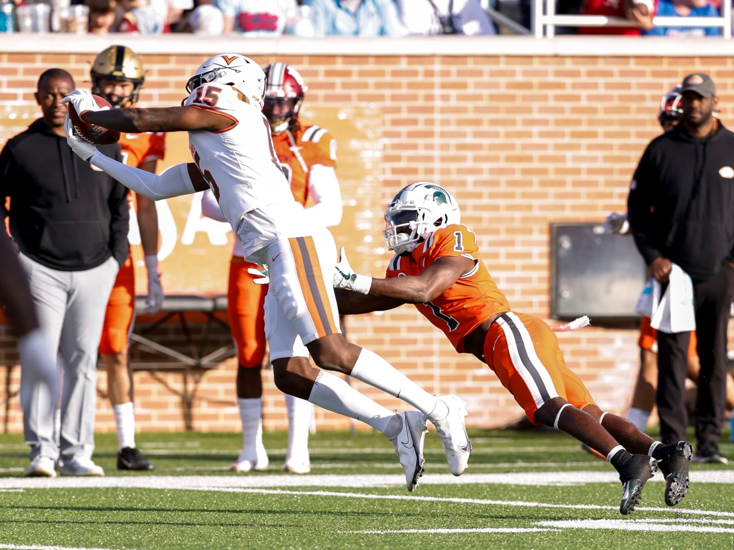 MOBILE, AL - FEBRUARY 04: Defensive Back Anthony Johnson #15 of Virginia from the American Team makes an interception over Wide Receiver Jayden Reed #1 of Michigan State from the National Team during the 2023 Resse's Senior Bowl at Hancock Whitney Stadium on the campus of the University of South Alabama on February 4, 2023 in Mobile, Alabama. The National defeated the American 27 to 10. (Photo by Don Juan Moore/Getty Images)