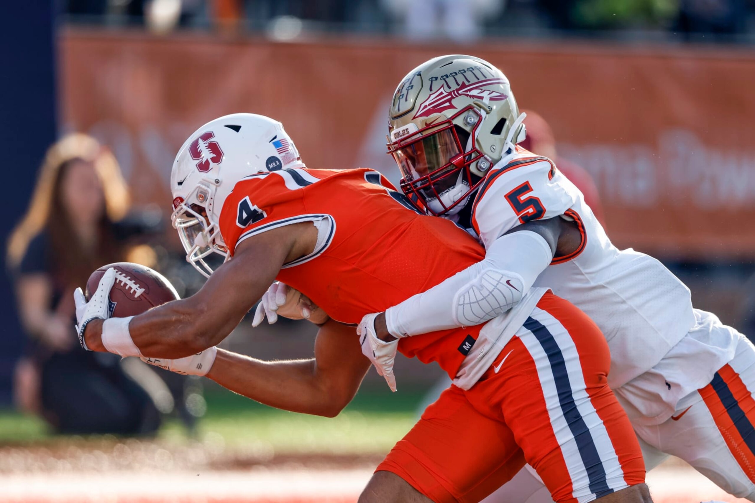 National wide receiver Michael Wilson of Stanford (4) reaches for the end zone for a touchdown as American defensive back Jammie Robinson of Florida State (5) defends during the second half of the Senior Bowl NCAA college football game, Saturday, Feb. 4, 2023, in Mobile, Ala.. (AP Photo/Butch Dill)