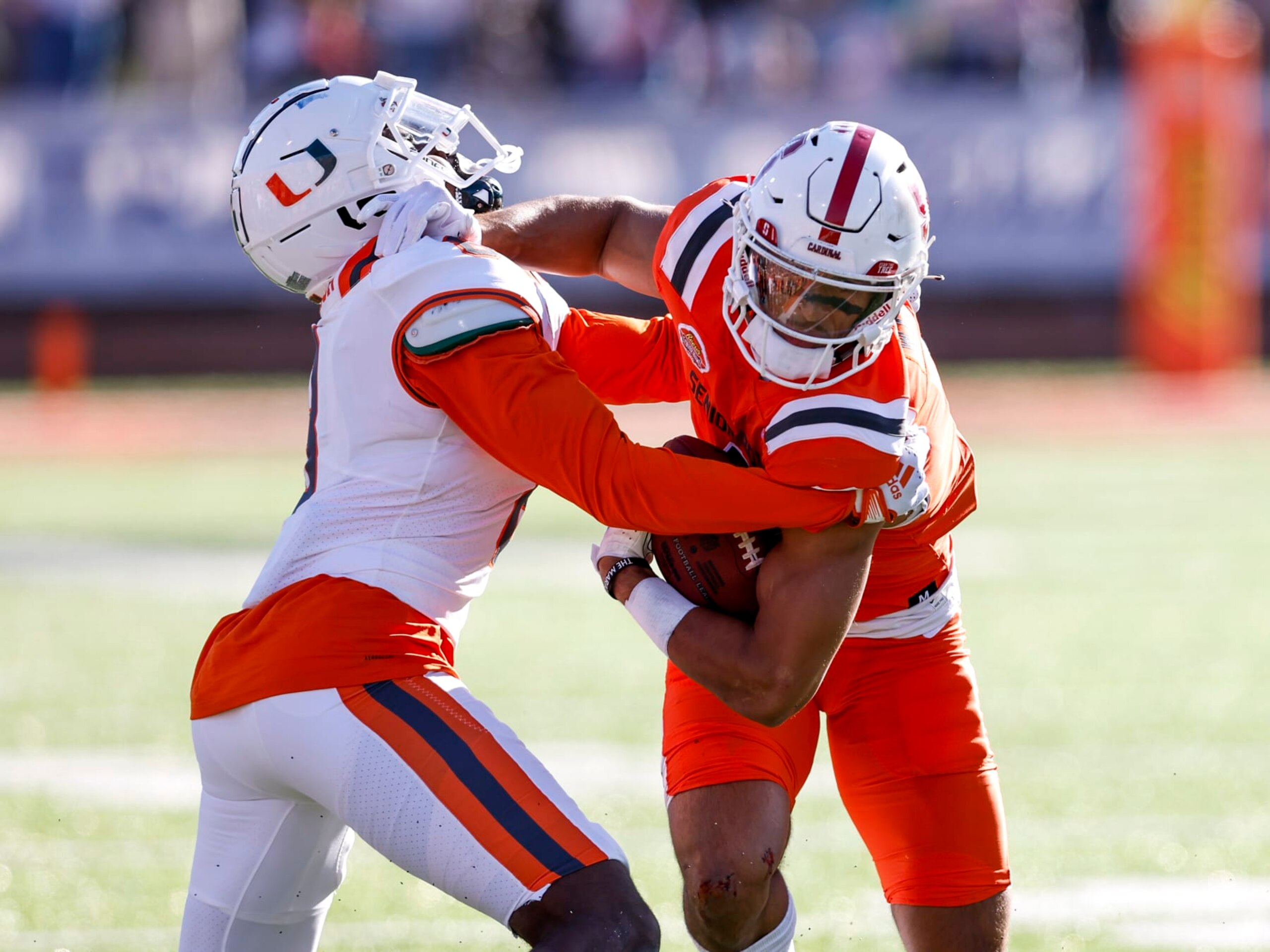 MOBILE, AL - FEBRUARY 04: Wide Receiver Michael Wilson #4 from Stanford from the National Team avoids being tackled by Miami Tyrique Stevenson #8 of Miami from the American Team during the 2023 Resse's Senior Bowl at Hancock Whitney Stadium on the campus of the University of South Alabama on February 4, 2023 in Mobile, Alabama. The National defeated the American 27 to 10. (Photo by Don Juan Moore/Getty Images)