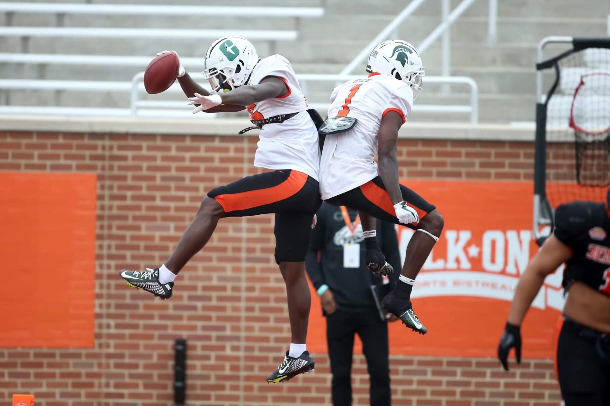 MOBILE, AL - FEBRUARY 02: National wide receiver Grant DuBose of Charlotte (15) and National wide receiver Jayden Reed of Michigan State (1) celebrate a touchdown during the Reese's Senior Bowl team practice session on February 2, 2023 at Hancock Whitney Stadium in Mobile, Alabama.  (Photo by Michael Wade/Icon Sportswire via Getty Images)