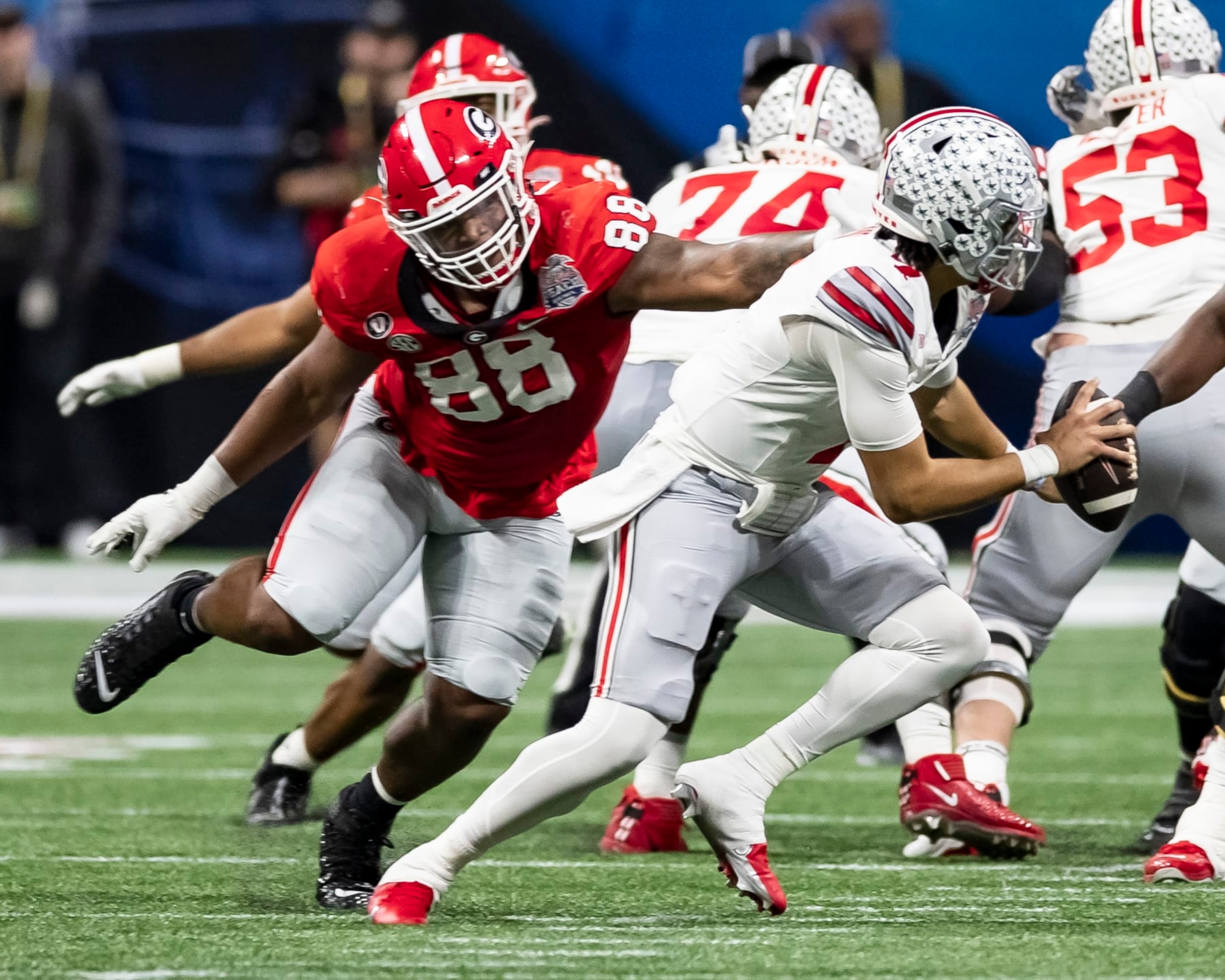 ATLANTA, GA - DECEMBER 31: C.J. Stroud #7 of the Ohio State Buckeyes avoids a sack by Jalen Carter #88 of the Georgia Bulldogs during a game between Ohio State Buckeyes and Georgia Bulldogs at Mercedes-Benz Stadium on December 31, 2022 in Atlanta, Georgia. (Photo by Steve Limentani/ISI Photos/Getty Images)