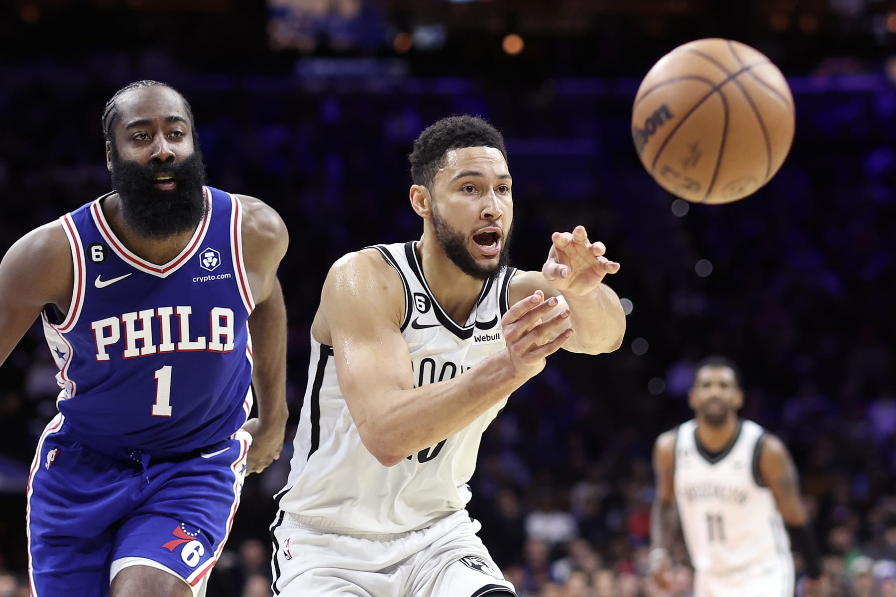 PHILADELPHIA, PENNSYLVANIA - JANUARY 25: Ben Simmons #10 of the Brooklyn Nets passes past James Harden #1 of the Philadelphia 76ers during the fourth quarter at Wells Fargo Center on January 25, 2023 in Philadelphia, Pennsylvania. NOTE TO USER: User expressly acknowledges and agrees that, by downloading and or using this photograph, User is consenting to the terms and conditions of the Getty Images License Agreement. (Photo by Tim Nwachukwu/Getty Images)
