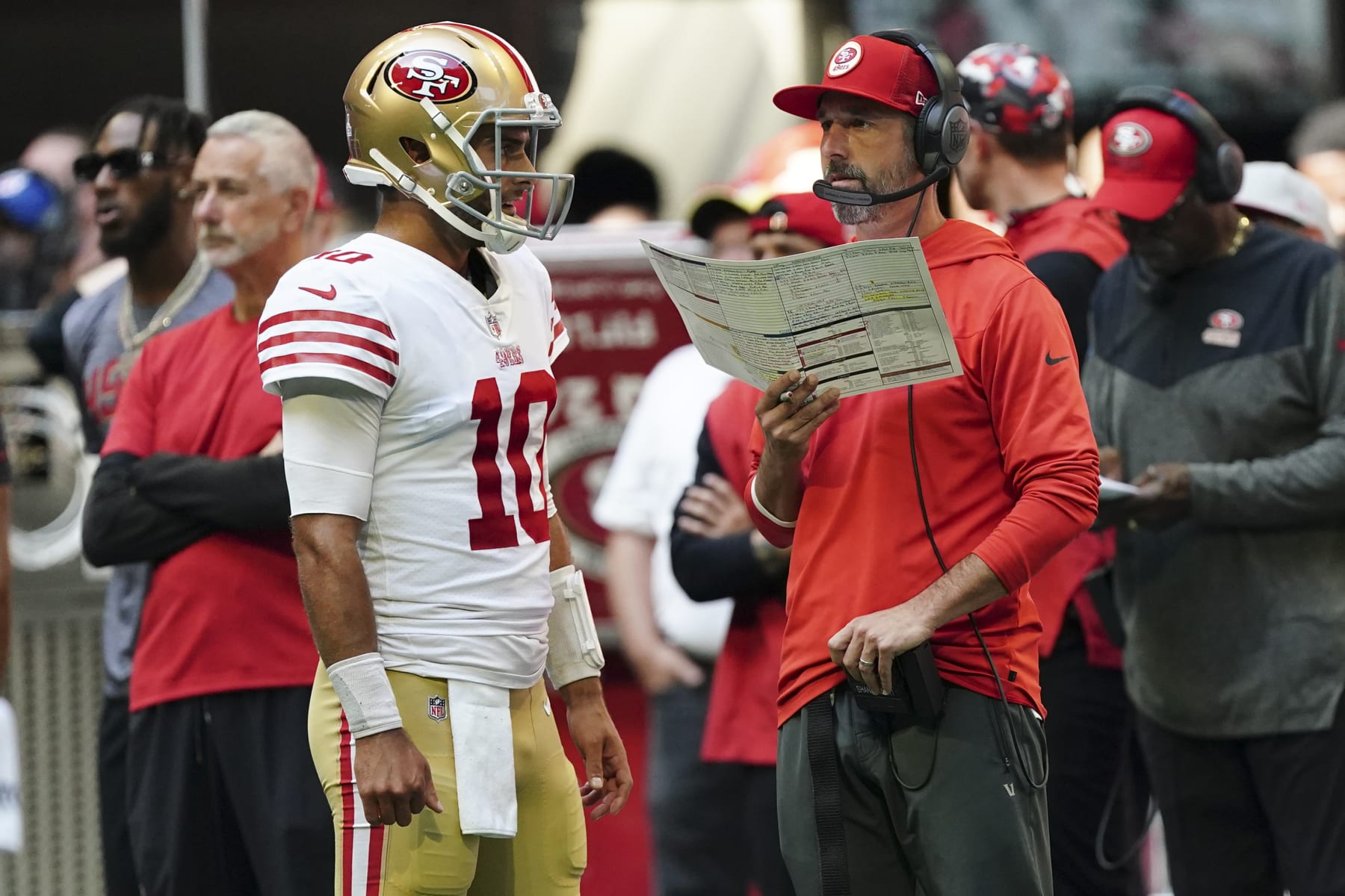 San Francisco 49ers quarterback Jimmy Garoppolo (10) and head coach Kyle Shanahan talk during an NFL football game against the Atlanta Falcons Sunday, Oct. 16, 2022, in Atlanta. (AP Photo/John Bazemore)