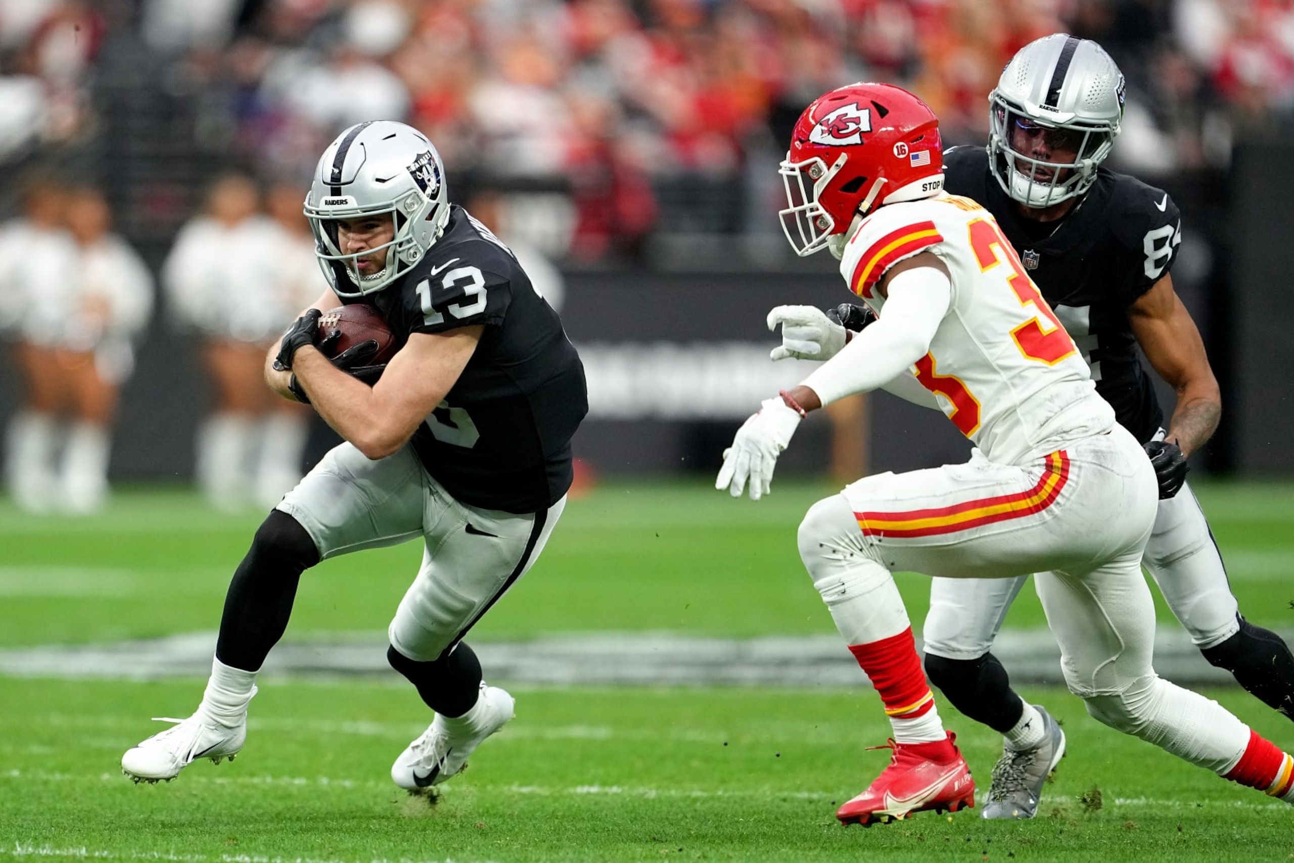 LAS VEGAS, NEVADA - JANUARY 07: Hunter Renfrow #13 of the Las Vegas Raiders carries the ball against the Kansas City Chiefs during the first half of the game at Allegiant Stadium on January 07, 2023 in Las Vegas, Nevada. (Photo by Jeff Bottari/Getty Images) LAS VEGAS, NEVADA - JANUARY 07: Hunter Renfrow #13 of the Las Vegas Raiders carries the ball against the Kansas City Chiefs during the first half of the game at Allegiant Stadium on January 07, 2023 in Las Vegas, Nevada. (Photo by Jeff Bottari/Getty Images)