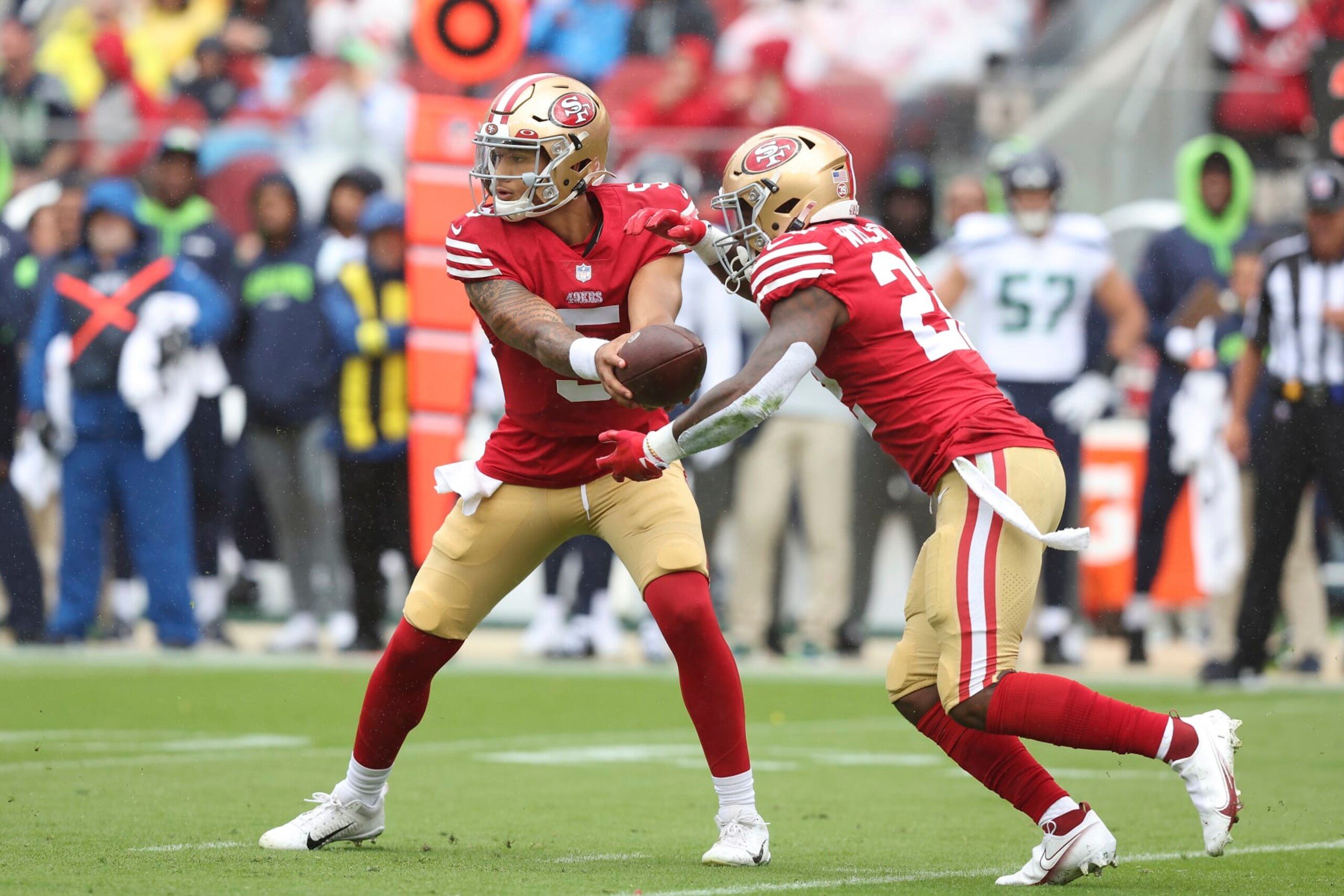 San Francisco 49ers quarterback Trey Lance (5) hands the ball off to running back Jeff Wilson Jr. (22) during an NFL football game Seattle Seahawks, Sunday, Sept. 18, 2022 in Santa Clara, Calif. (AP Photo/Lachlan Cunningham)