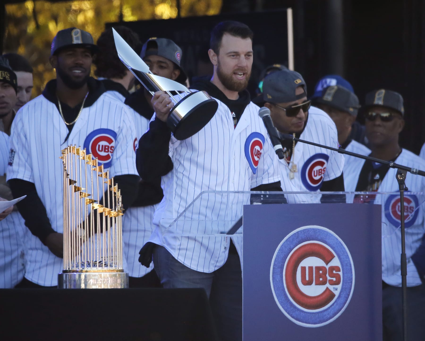 Chicago Cubs Ben Zobrist holds up the World Series MVP trophy and addresses the crowd during a celebration in Grant Park honoring the World Series baseball champions Friday, Nov. 4, 2016, in Chicago. (AP Photo/Charles Rex Arbogast)
