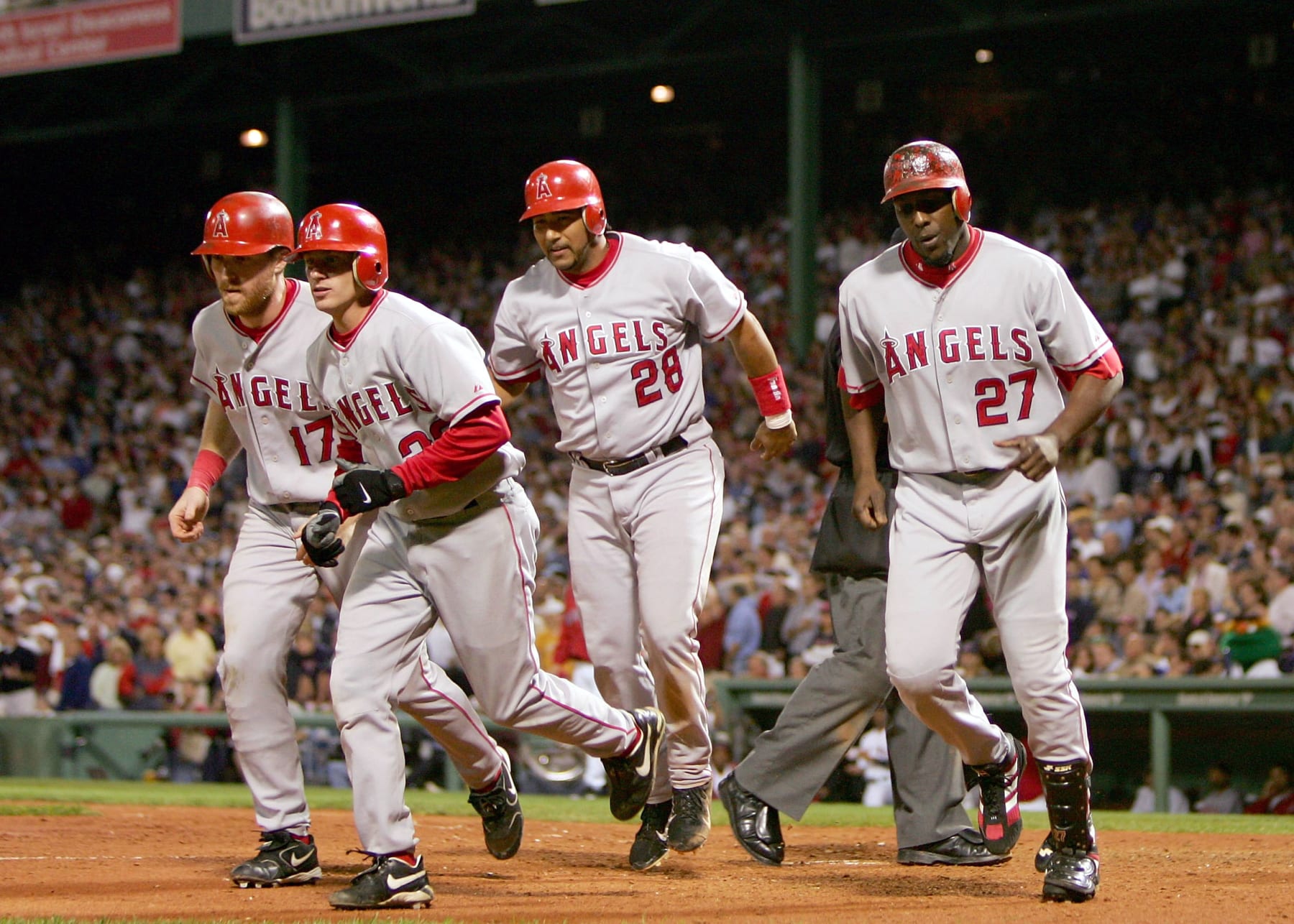 BOSTON - OCTOBER 8:  (L-R)  Darin Erstad #17, David Eckstein #22, Jose Molina #28 and Vladimir Guerrero #27 of the Anaheim Angels return to the dugout after Guerrero hit a grand slam home run in the seventh inning of Game 3 of the American League Division Series to tie the game at 6-6 against the Boston Red Sox October 8, 2004 at Fenway Park in Boston, Massachusetts.  (Photo by Ezra Shaw/Getty Images)