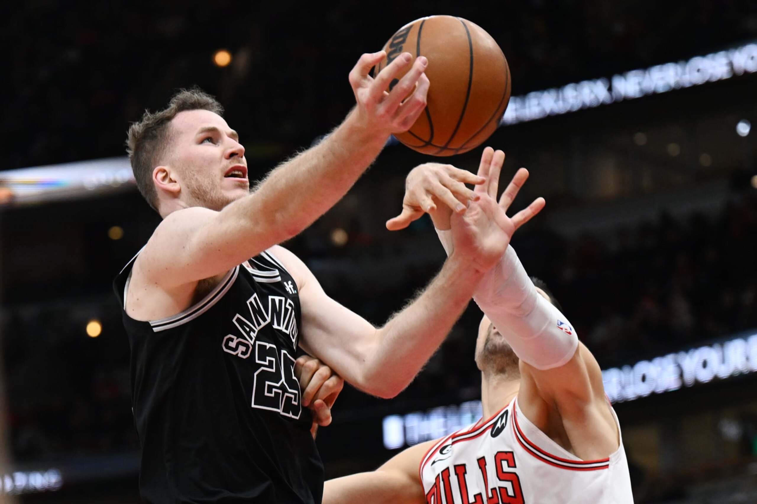 CHICAGO, ILLINOIS - FEBRUARY 06: Jakob Poeltl #25 of the San Antonio Spurs is fouled in the first half against Nikola Vucevic #9 of the Chicago Bulls at United Center on February 06, 2023 in Chicago, Illinois. NOTE TO USER: User expressly acknowledges and agrees that, by downloading and or using this photograph, User is consenting to the terms and conditions of the Getty Images License Agreement.  (Photo by Quinn Harris/Getty Images)