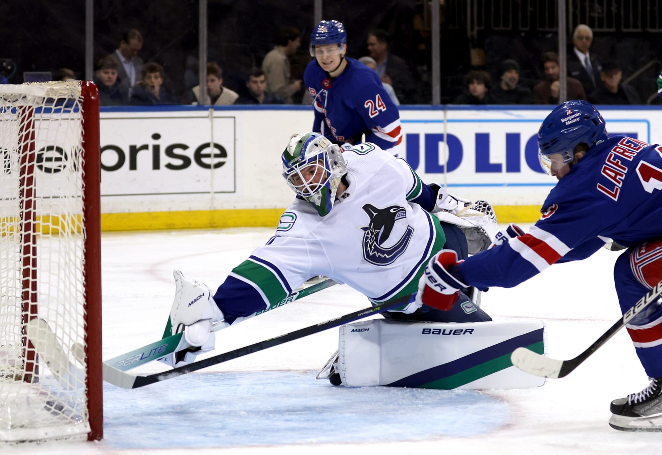 NEW YORK, NEW YORK - FEBRUARY 08:  Alexis Lafrenière #13 of the New York Rangers shoots past goaltender Spencer Martin #30 of the Vancouver Canucks to score during the 2nd period of the game at Madison Square Garden on February 08, 2023 in New York City. (Photo by Jamie Squire/Getty Images)