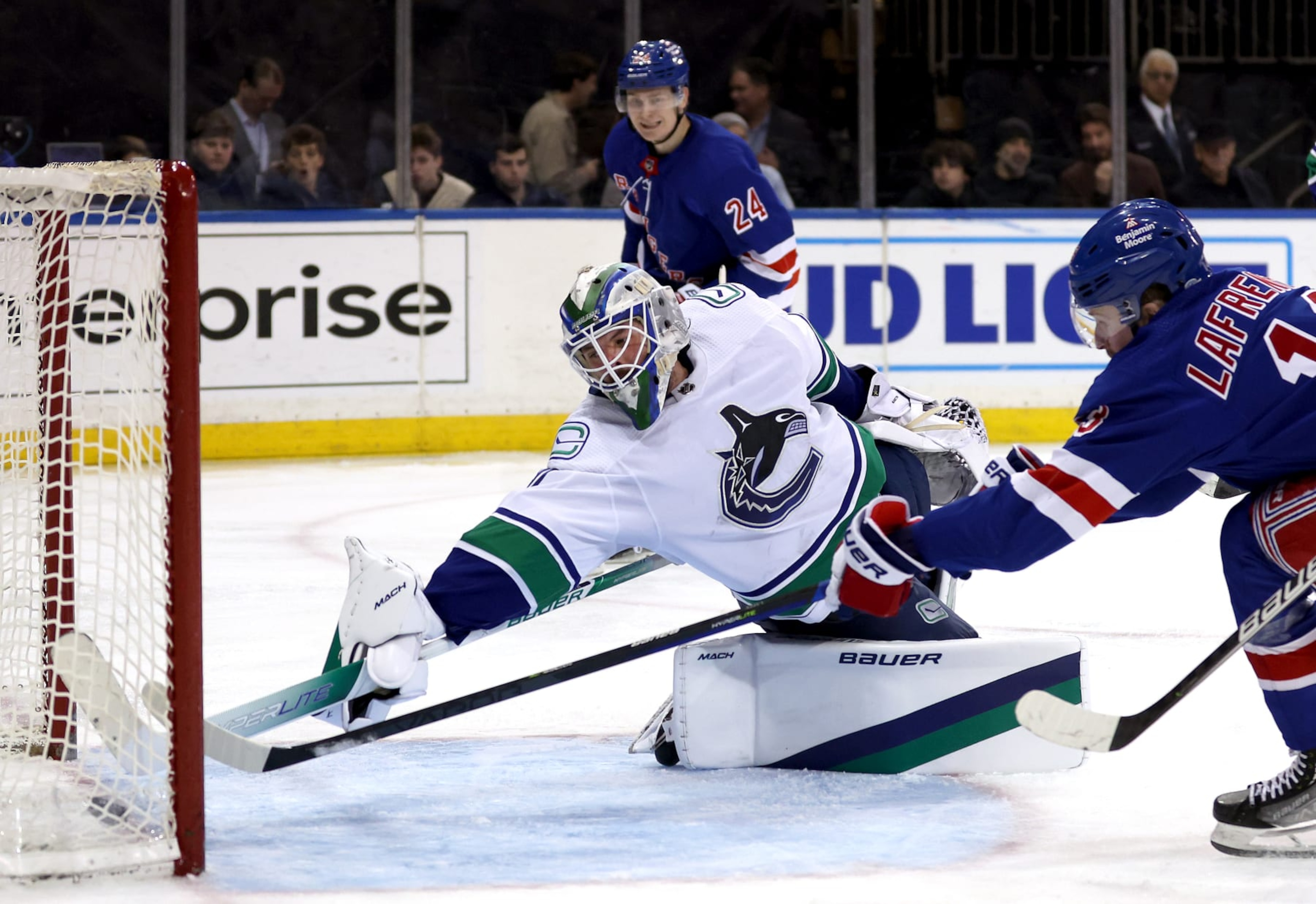 NEW YORK, NEW YORK - FEBRUARY 08:  Alexis Lafrenière #13 of the New York Rangers shoots past goaltender Spencer Martin #30 of the Vancouver Canucks to score during the 2nd period of the game at Madison Square Garden on February 08, 2023 in New York City. (Photo by Jamie Squire/Getty Images)