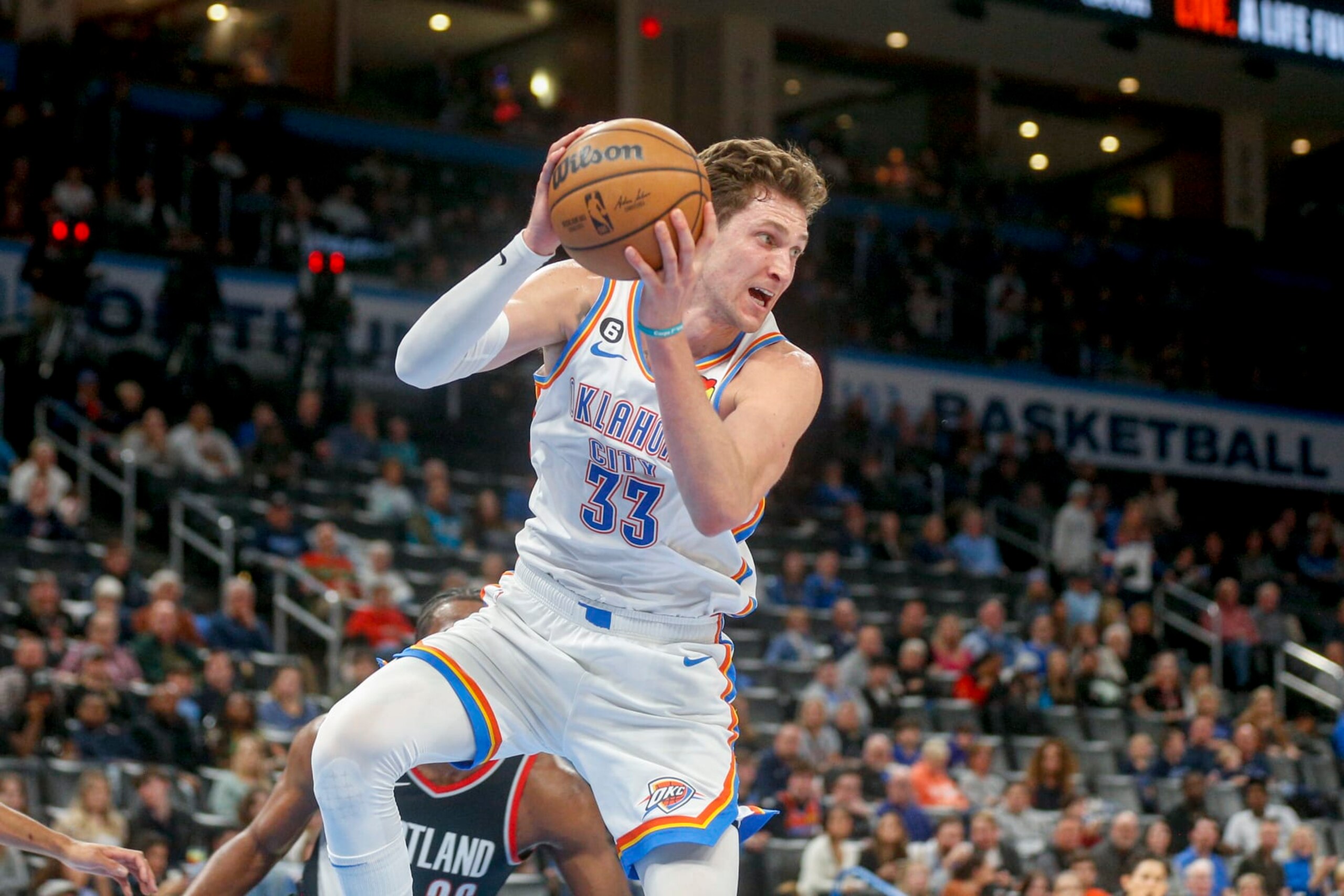 OKLAHOMA CITY, OKLAHOMA - DECEMBER 19: Mike Muscala #33 of the Oklahoma City Thunder grabs a rebound during the fourth quarter against the Portland Trail Blazers at Paycom Center on December 19, 2022 in Oklahoma City, Oklahoma. NOTE TO USER: User expressly acknowledges and agrees that, by downloading and or using this photograph, User is consenting to the terms and conditions of the Getty Images License Agreement.  (Photo by Ian Maule/Getty Images)