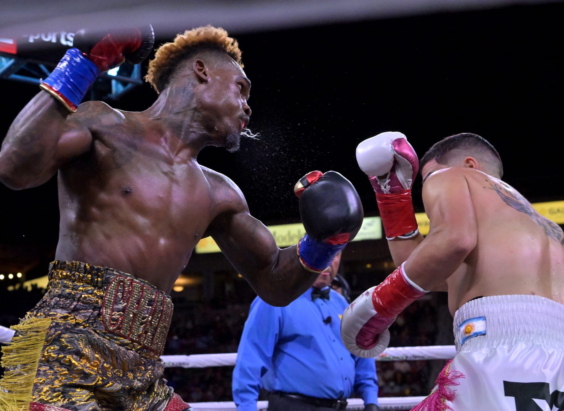CARSON, CA - MAY 14: Jermell Charlo (gold/red shorts) exchanges punches in the ring with Brian Castano (white/pink shorts) during their super middleweight title fight at Dignity Health Sports Park on May 14, 2022 in Carson, California. Charlo won by knockout in the 10th round. (Photo by Jayne Kamin-Oncea/Getty Images)