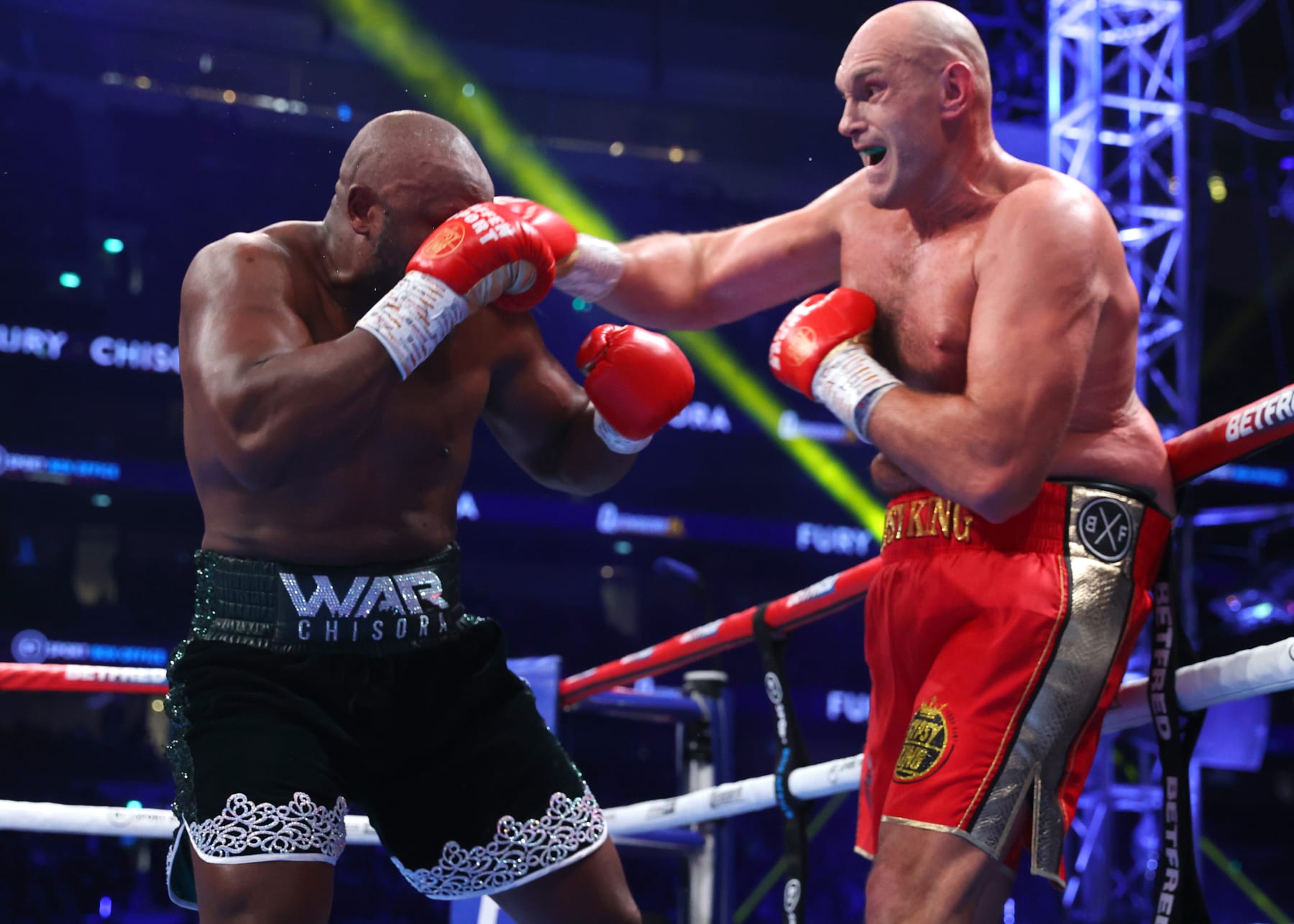 LONDON, ENGLAND - DECEMBER 03: Derek Chisora (L) and Tyson Fury (R) exchange punches during their WBC heavyweight championship fight, at Tottenham Hotspur Stadium on December 03, 2022 in London, England. (Photo by Mikey Williams/Top Rank Inc via Getty Images)