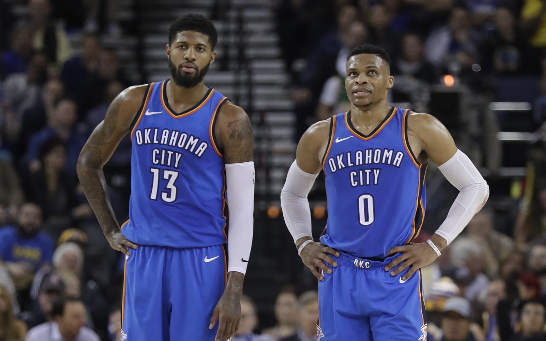 Oklahoma City Thunder's Russell Westbrook (0) stands next to teammate Paul George (13) during the first half of an NBA basketball game against the Golden State Warriors Tuesday, Feb. 6, 2018, in Oakland, Calif. (AP Photo/Marcio Jose Sanchez)