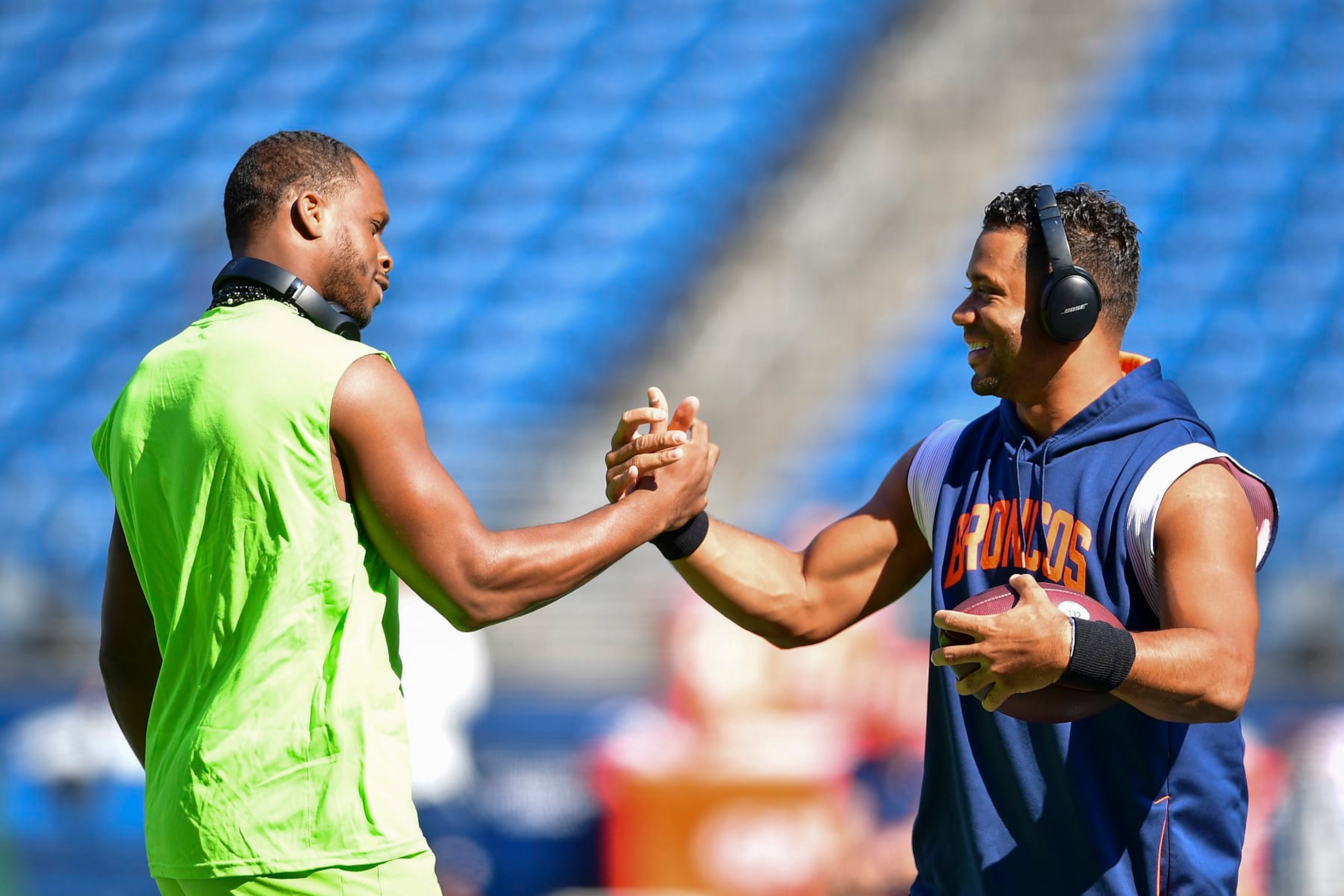 SEATTLE, WASHINGTON - SEPTEMBER 12: Geno Smith #7 of the Seattle Seahawks (L) and Russell Wilson #3 of the Denver Broncos shake hands before a game at Lumen Field on September 12, 2022 in Seattle, Washington. (Photo by Jane Gershovich/Getty Images) SEATTLE, WASHINGTON - SEPTEMBER 12: Geno Smith #7 of the Seattle Seahawks (L) and Russell Wilson #3 of the Denver Broncos shake hands before a game at Lumen Field on September 12, 2022 in Seattle, Washington. (Photo by Jane Gershovich/Getty Images)