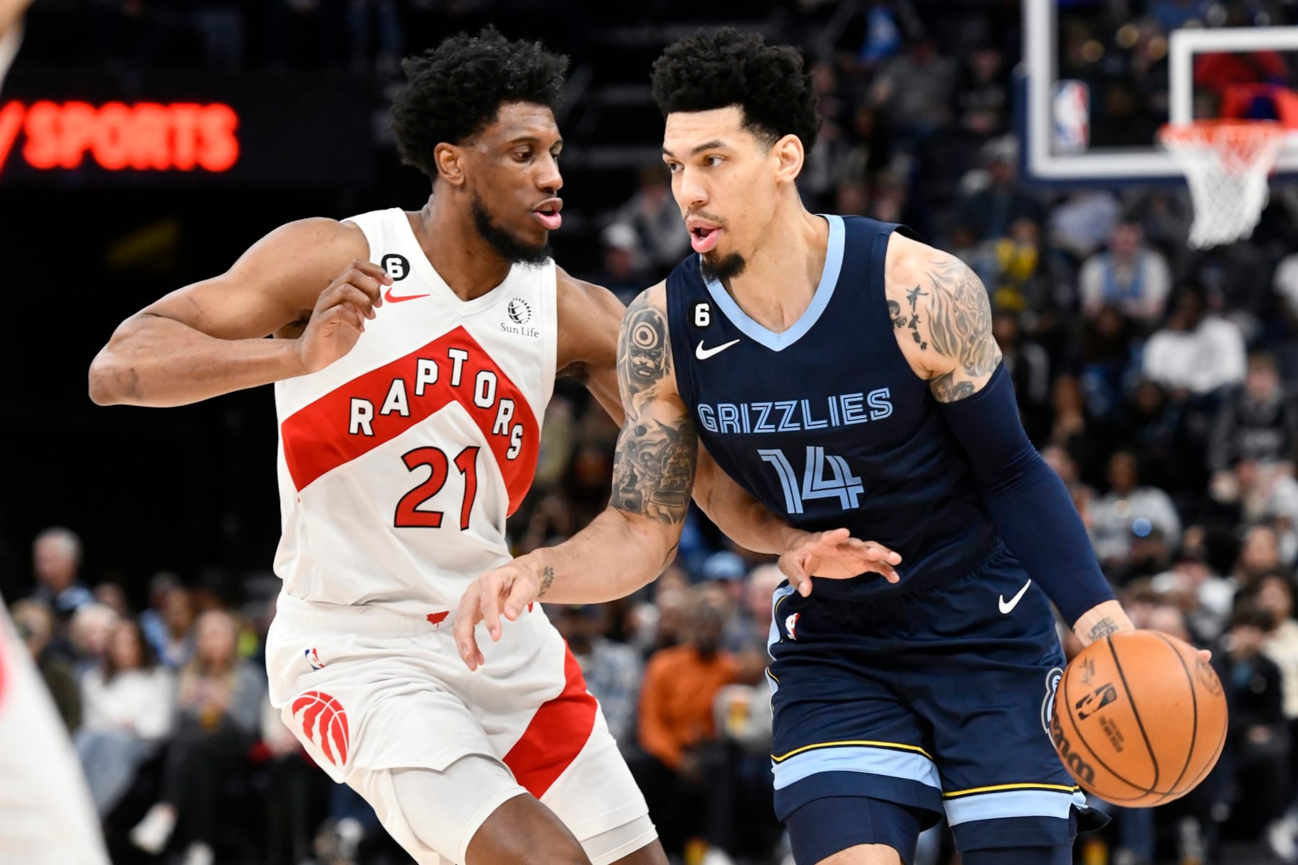 Memphis Grizzlies guard Danny Green (14) handles the ball against Toronto Raptors forward Thaddeus Young (21) in the second half of an NBA basketball game Sunday, Feb. 5, 2023, in Memphis, Tenn. (AP Photo/Brandon Dill)
