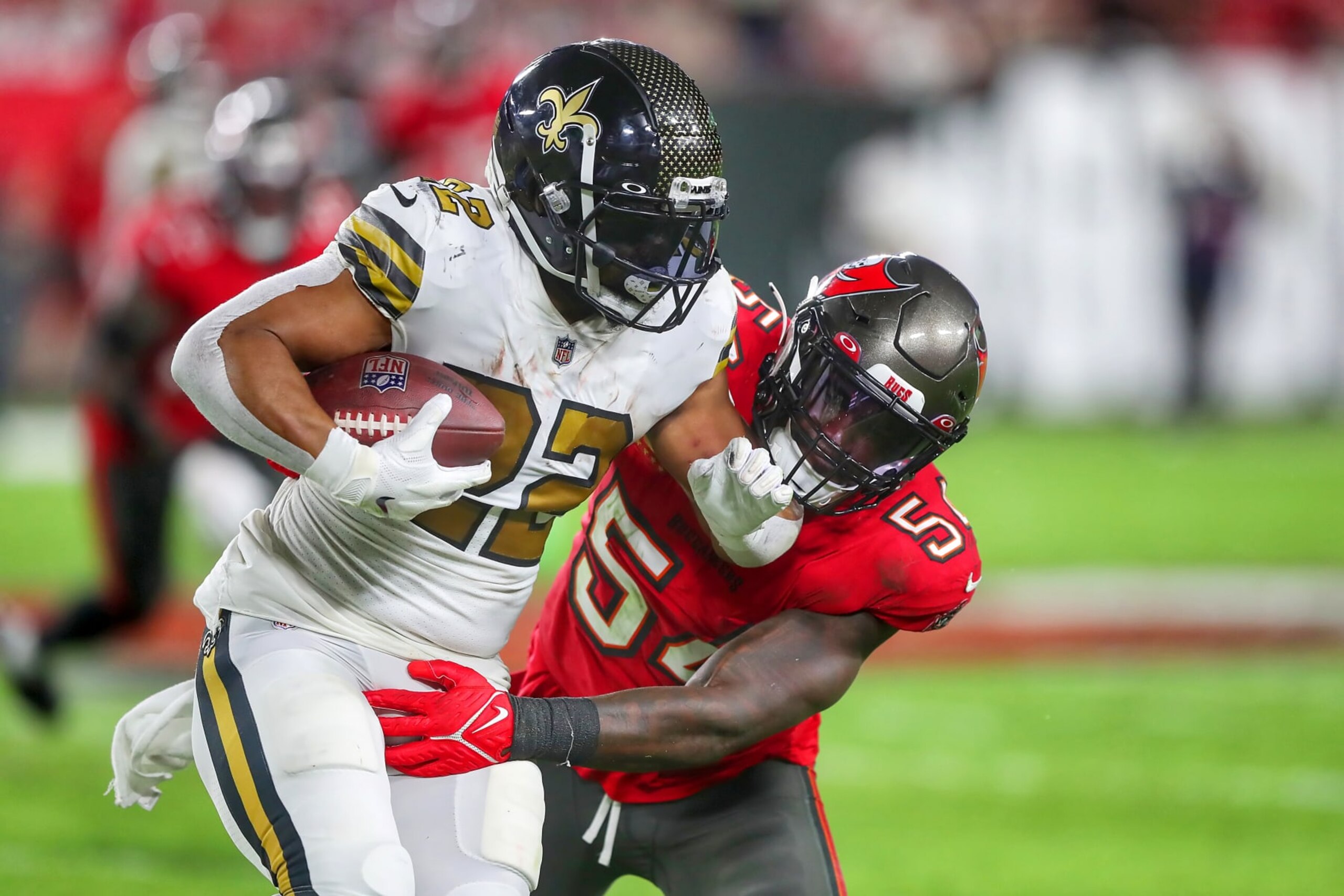 TAMPA, FL - DECEMBER 05: Tampa Bay Buccaneers Linebacker Lavonte David (54) wraps up New Orleans Saints running back Mark Ingram (22) during the regular season game between the New Orleans Saints and the Tampa Bay Buccaneers on December 05, 2022 at Raymond James Stadium in Tampa, Florida. (Photo by Cliff Welch/Icon Sportswire via Getty Images) TAMPA, FL - DECEMBER 05: Tampa Bay Buccaneers Linebacker Lavonte David (54) wraps up New Orleans Saints running back Mark Ingram (22) during the regular season game between the New Orleans Saints and the Tampa Bay Buccaneers on December 05, 2022 at Raymond James Stadium in Tampa, Florida. (Photo by Cliff Welch/Icon Sportswire via Getty Images)