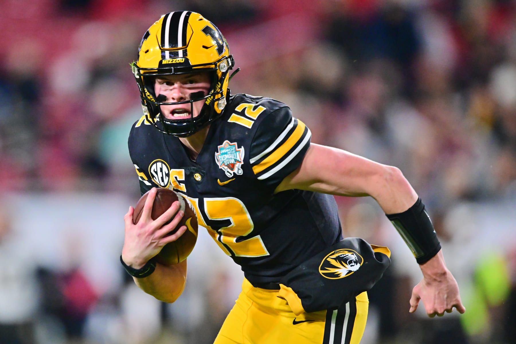 TAMPA, FLORIDA - DECEMBER 23: Brady Cook #12 of the Missouri Tigers scrambles with the ball in the second quarter against the Wake Forest Demon Deacons during the Union Home Mortgage Gasparilla Bowl at Raymond James Stadium on December 23, 2022 in Tampa, Florida. (Photo by Julio Aguilar/Getty Images)