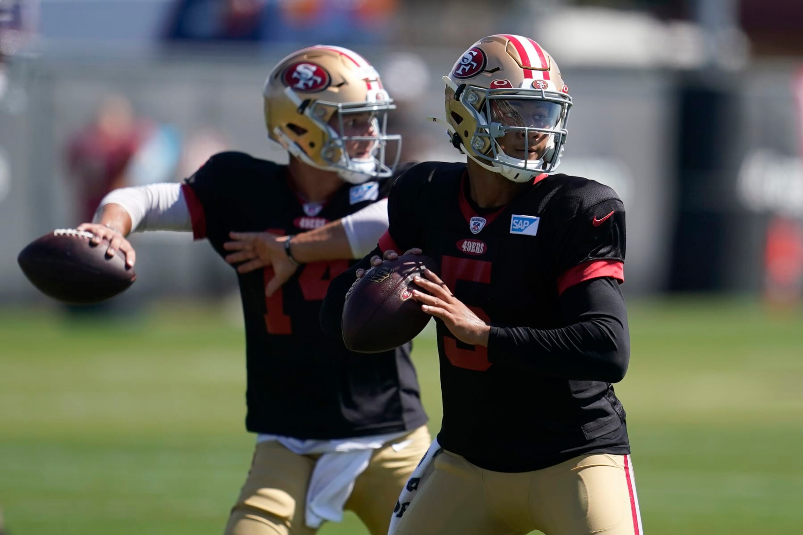 San Francisco 49ers quarterbacks Trey Lance (5) and Brock Purdy take part in drills at the NFL football team's practice facility in Santa Clara, Calif., Friday, Aug. 5, 2022. (AP Photo/Jeff Chiu)