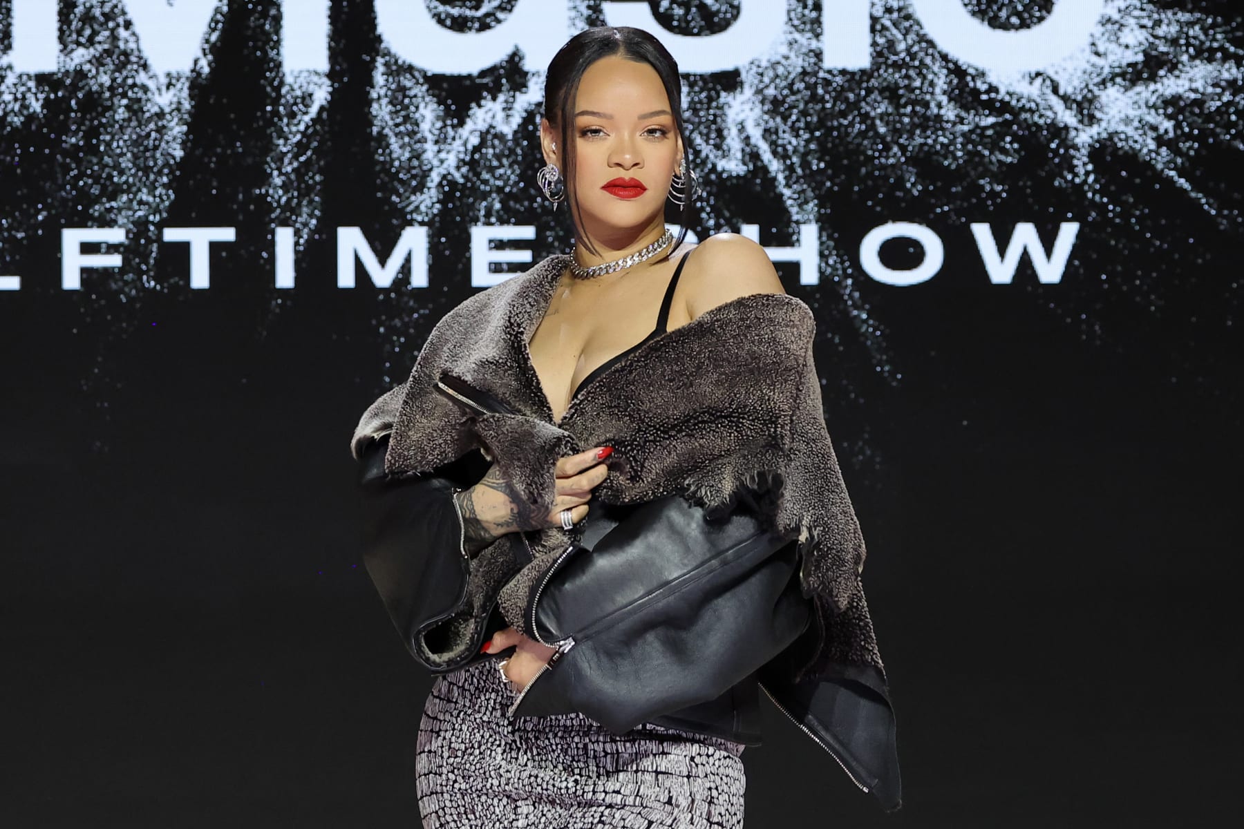 PHOENIX, ARIZONA - FEBRUARY 09: Rihanna speaks onstage during the Super Bowl LVII Pregame & Apple Music Super Bowl LVII Halftime Show Press Conference at Phoenix Convention Center on February 09, 2023 in Phoenix, Arizona. (Photo by Mike Coppola/Getty Images)