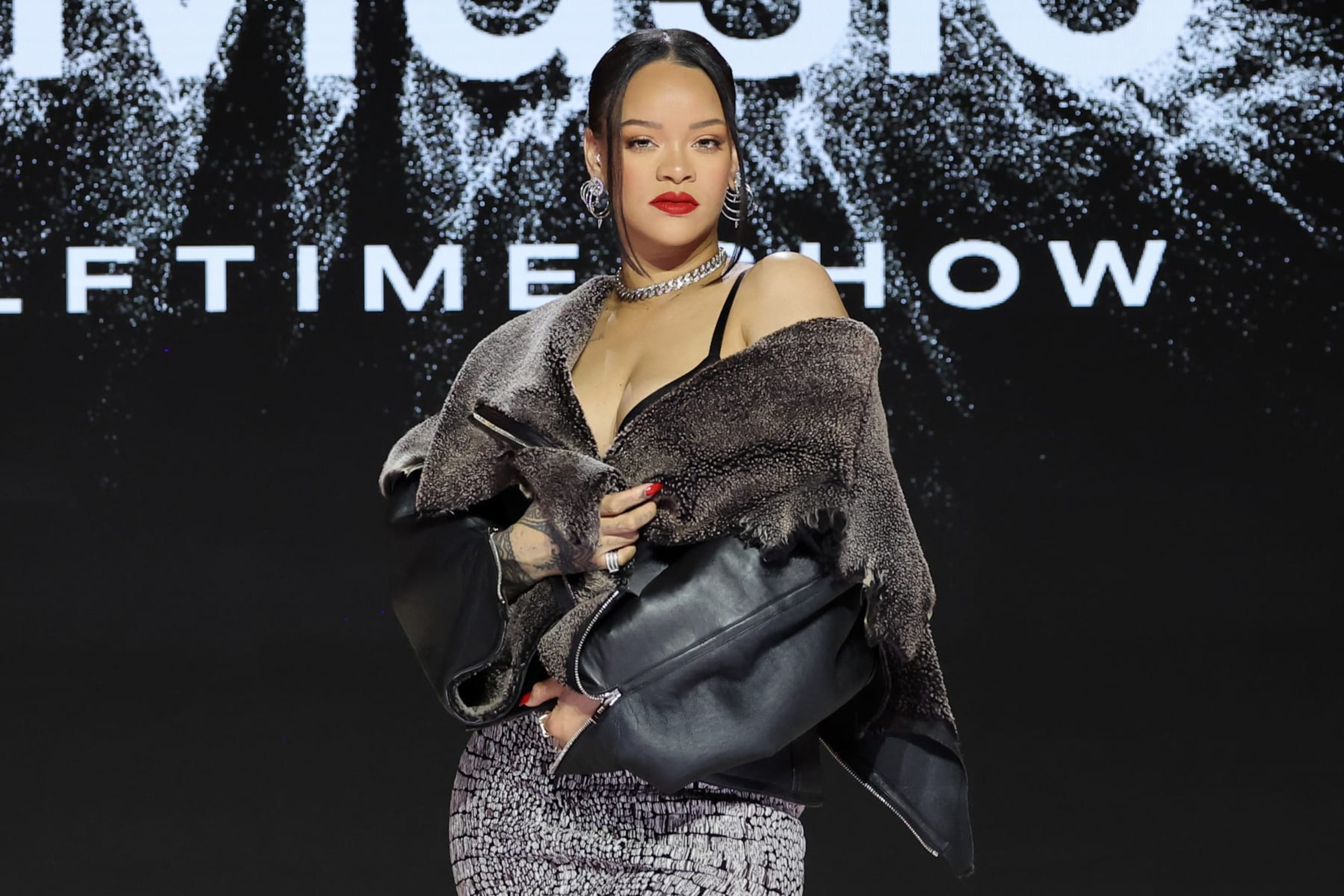 PHOENIX, ARIZONA - FEBRUARY 09: Rihanna speaks onstage during the Super Bowl LVII Pregame & Apple Music Super Bowl LVII Halftime Show Press Conference at Phoenix Convention Center on February 09, 2023 in Phoenix, Arizona. (Photo by Mike Coppola/Getty Images)