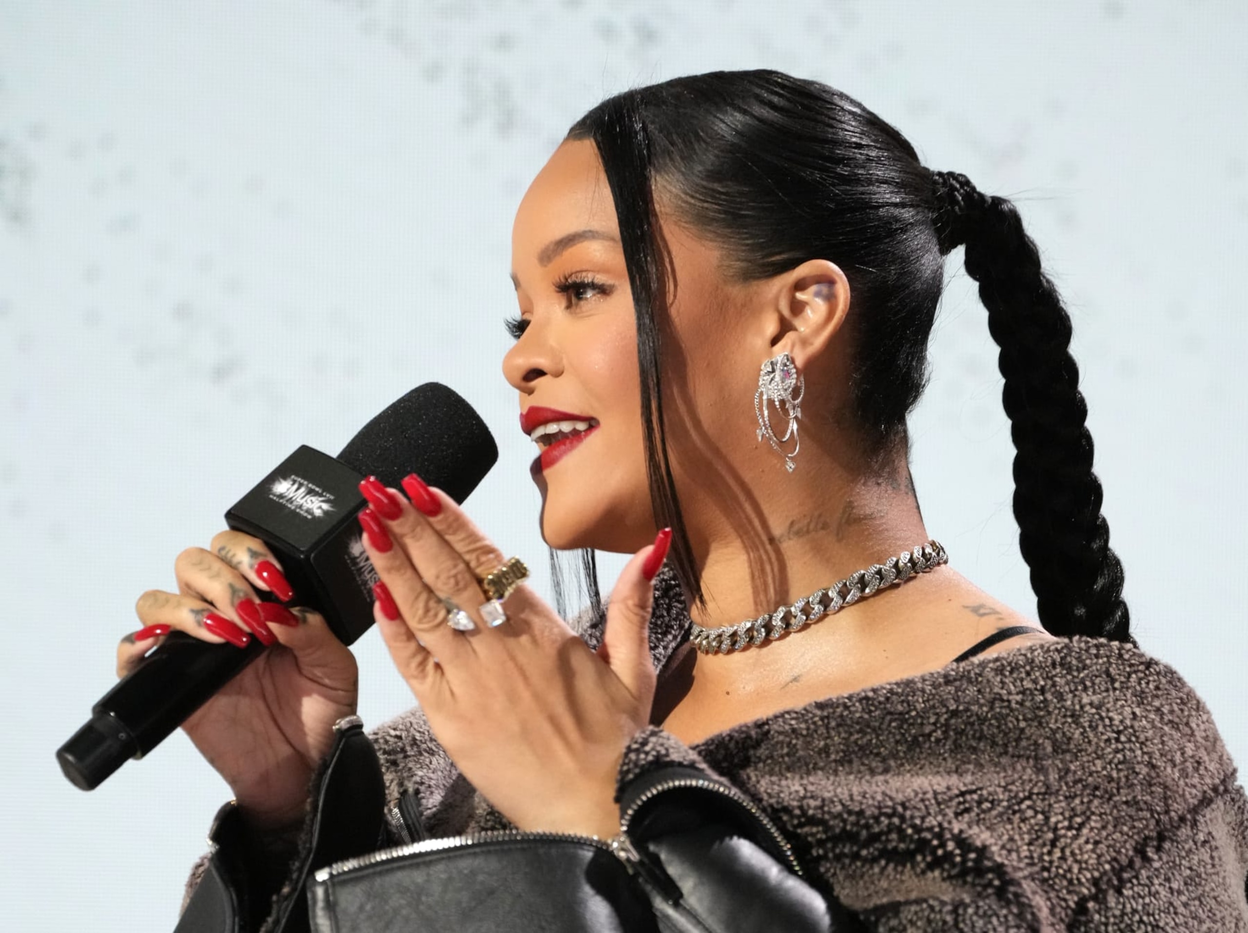 PHOENIX, ARIZONA - FEBRUARY 09:  Rihanna speaks onstage during the Apple Music Super Bowl LVII Halftime Show Press Conference at Phoenix Convention Center on February 09, 2023 in Phoenix, Arizona. (Photo by Kevin Mazur/Getty Images for Roc Nation)