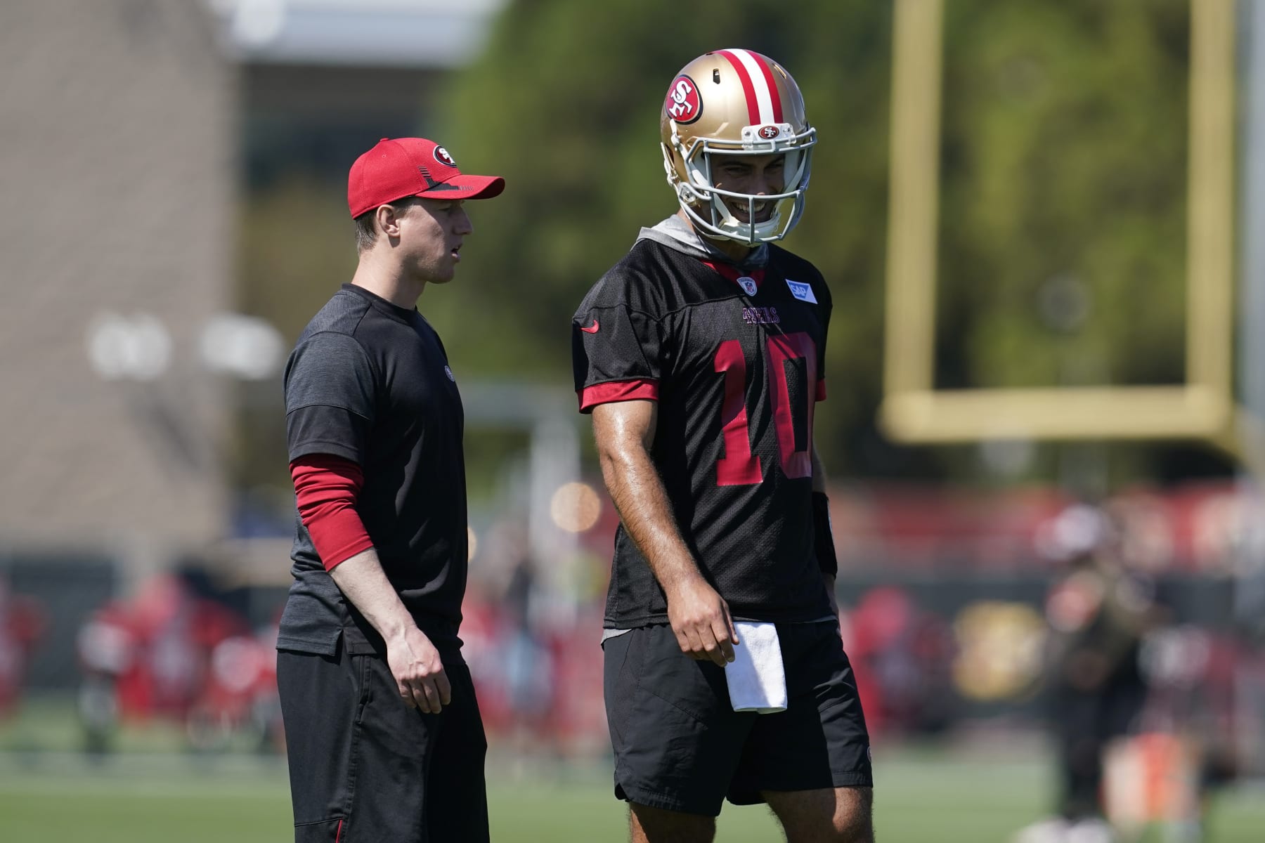 San Francisco 49ers' Jimmy Garoppolo, right, and offensive passing game coordinator Bobby Slowik take part in drills at the NFL football team's practice facility in Santa Clara, Calif., Thursday, Sept. 1, 2022. (AP Photo/Jeff Chiu)