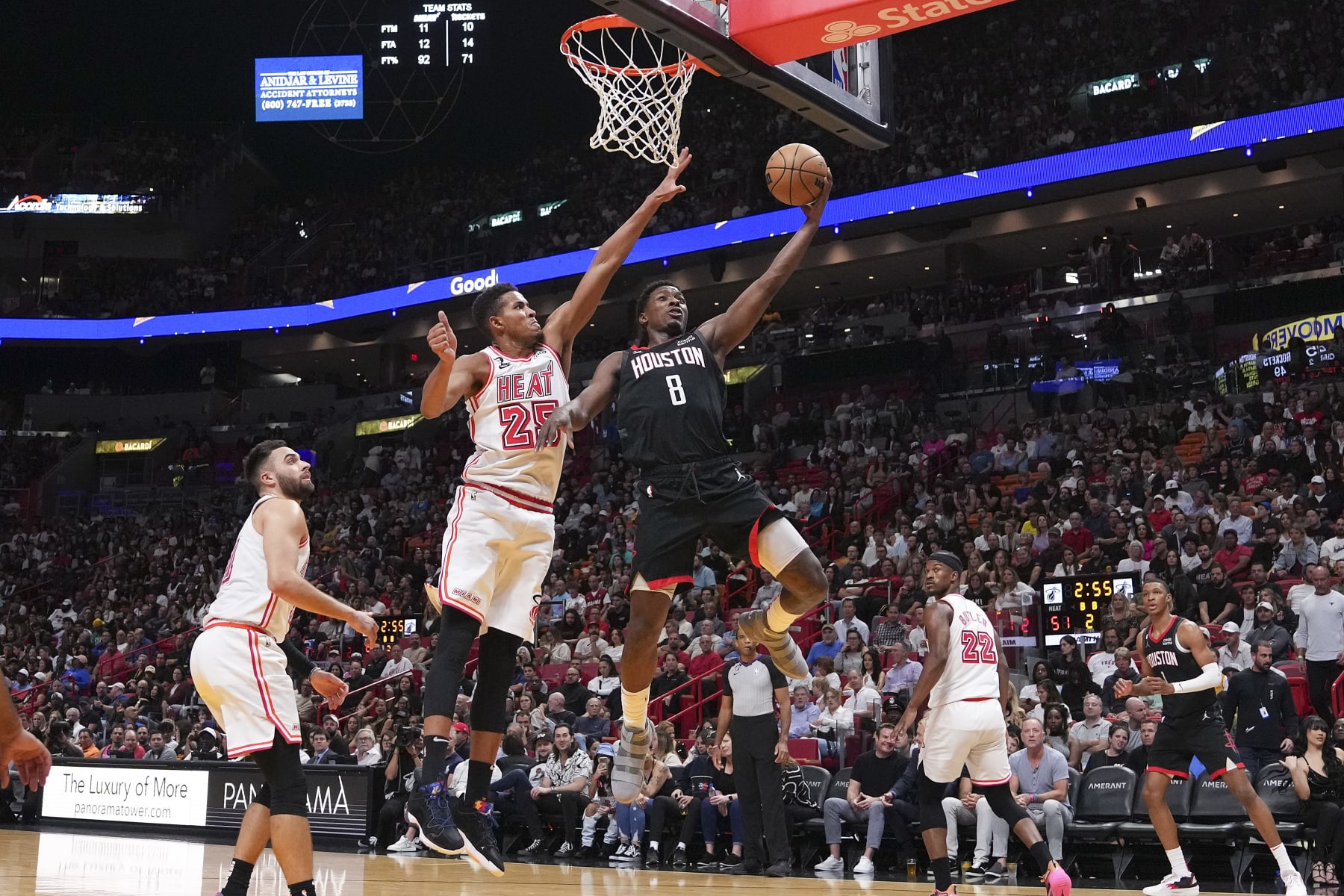 MIAMI, FLORIDA - FEBRUARY 10: Justin Holiday #8 of the Houston Rockets attempts a layup past Orlando Robinson #25 of the Miami Heat during the first half at Miami-Dade Arena on February 10, 2023 in Miami, Florida. NOTE TO USER: User expressly acknowledges and agrees that,  by downloading and or using this photograph,  User is consenting to the terms and conditions of the Getty Images License Agreement. (Photo by Eric Espada/Getty Images)