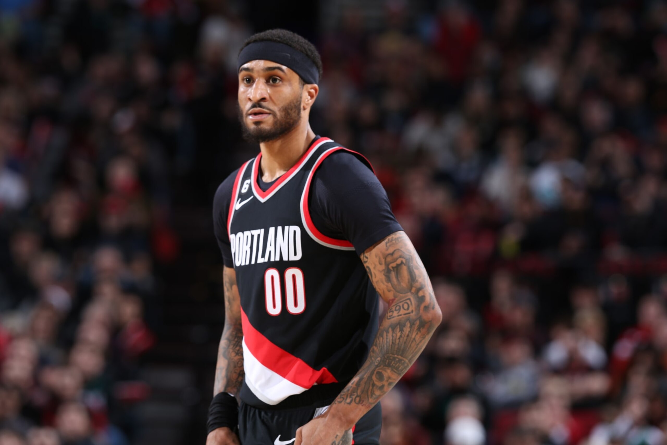 PORTLAND, OR - JANUARY 15: Gary Payton II #00 of the Portland Trail Blazers looks on during the game against the Dallas Mavericks on January 15, 2023 at the Moda Center Arena in Portland, Oregon. NOTE TO USER: User expressly acknowledges and agrees that, by downloading and or using this photograph, user is consenting to the terms and conditions of the Getty Images License Agreement. Mandatory Copyright Notice: Copyright 2022 NBAE (Photo by Sam Forencich/NBAE via Getty Images) PORTLAND, OR - JANUARY 15: Gary Payton II #00 of the Portland Trail Blazers looks on during the game against the Dallas Mavericks on January 15, 2023 at the Moda Center Arena in Portland, Oregon. NOTE TO USER: User expressly acknowledges and agrees that, by downloading and or using this photograph, user is consenting to the terms and conditions of the Getty Images License Agreement. Mandatory Copyright Notice: Copyright 2022 NBAE (Photo by Sam Forencich/NBAE via Getty Images)