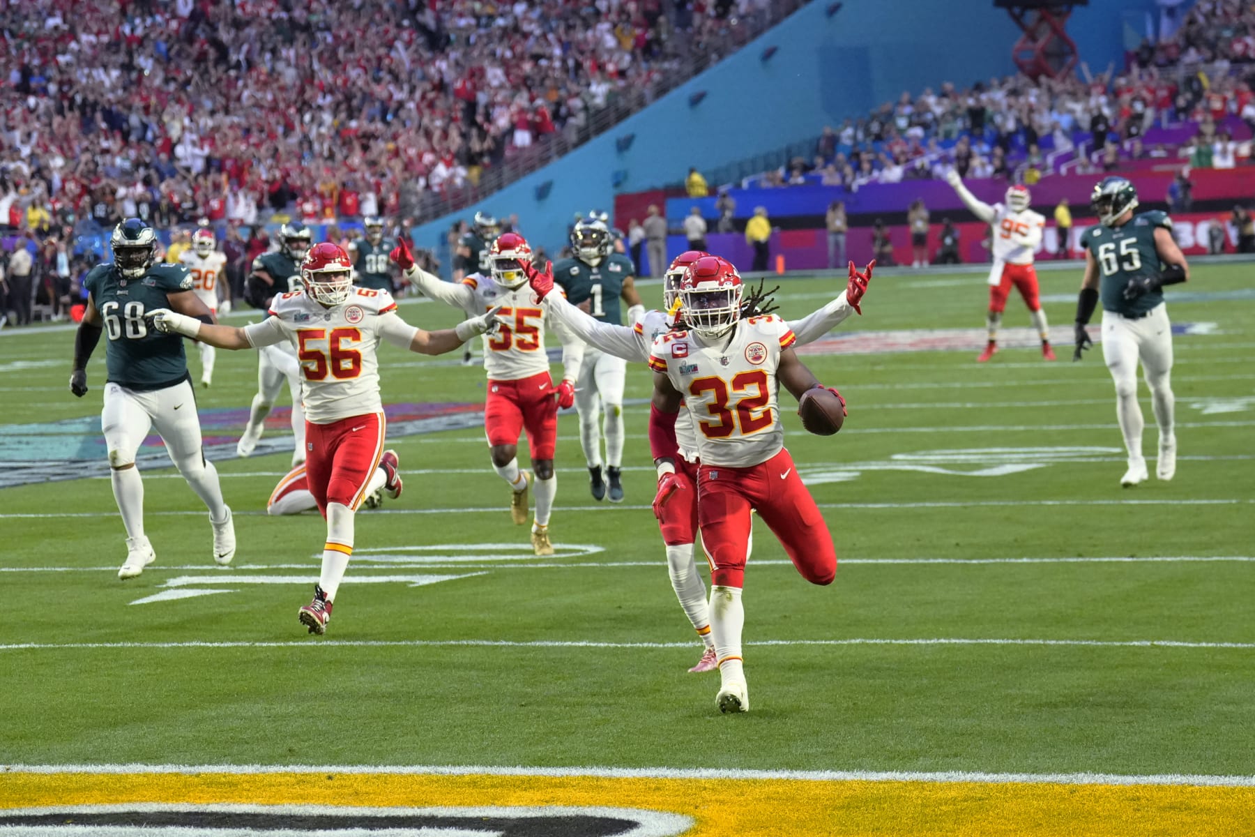 Kansas City Chiefs linebacker Nick Bolton (32) scores a touchdown after recovering a fumble by Philadelphia Eagles quarterback Jalen Hurts (1) during the first half of the NFL Super Bowl 57 football game between the Kansas City Chiefs and the Philadelphia Eagles, Sunday, Feb. 12, 2023, in Glendale, Ariz. (AP Photo/Ross D. Franklin)