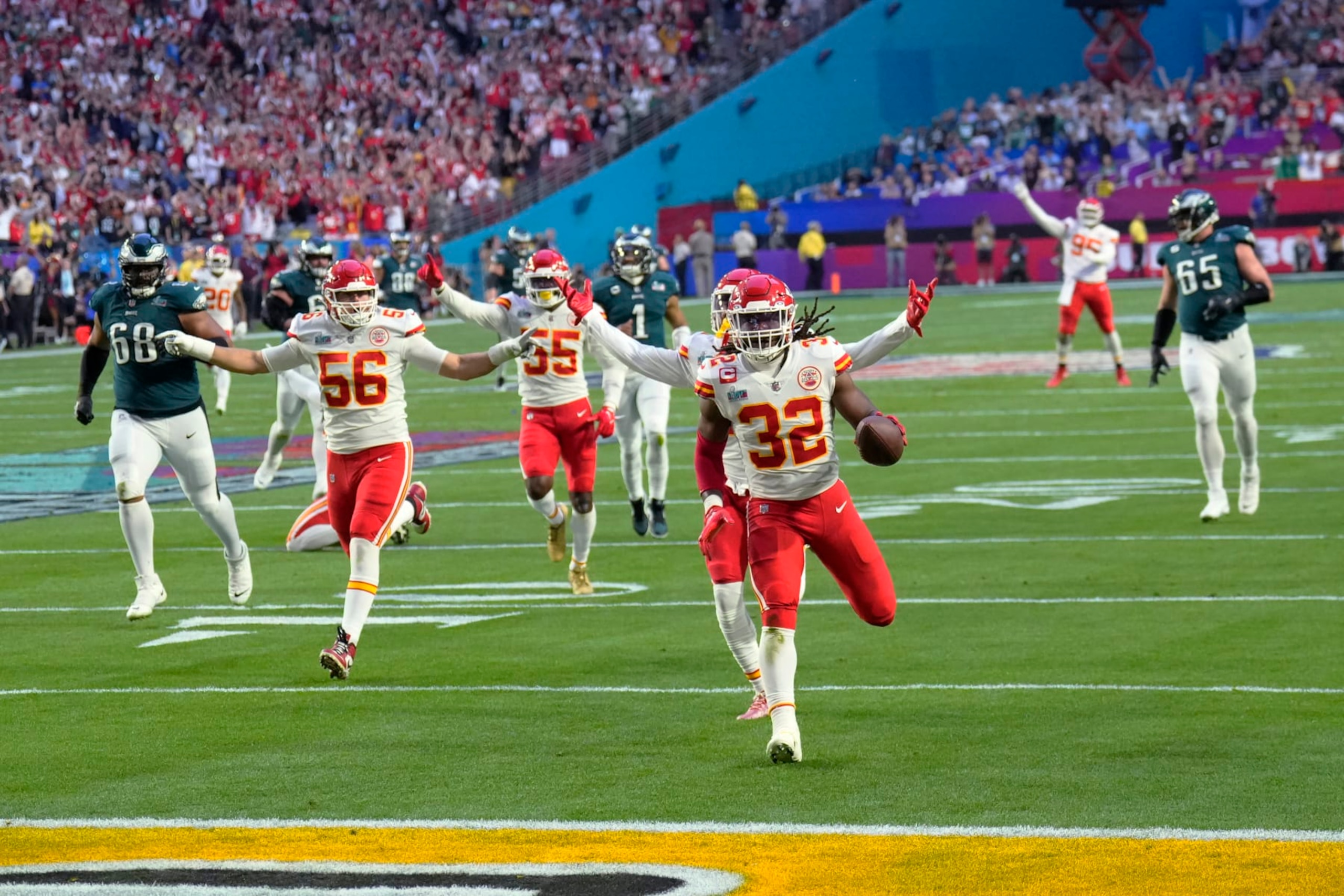 Kansas City Chiefs linebacker Nick Bolton (32) scores a touchdown after recovering a fumble by Philadelphia Eagles quarterback Jalen Hurts (1) during the first half of the NFL Super Bowl 57 football game between the Kansas City Chiefs and the Philadelphia Eagles, Sunday, Feb. 12, 2023, in Glendale, Ariz. (AP Photo/Ross D. Franklin)