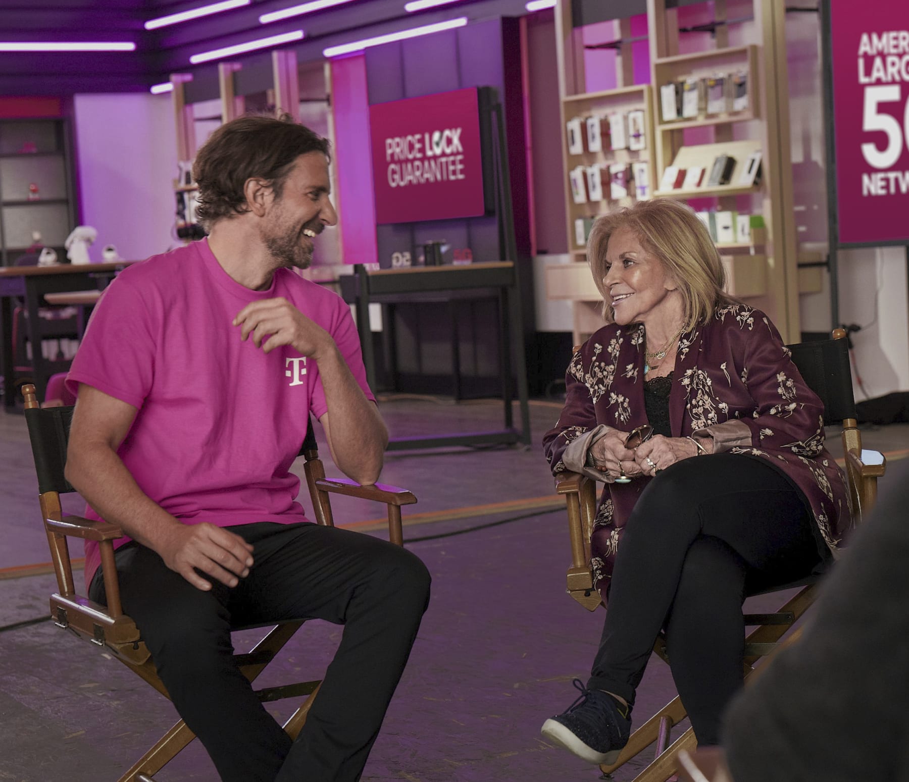 This photo provided by T-Mobile shows Bradley Cooper and his mother Gloria Campano in scene from T-Mobile 2023 Super Bowl NFL football spot. ( T-Mobile via AP)